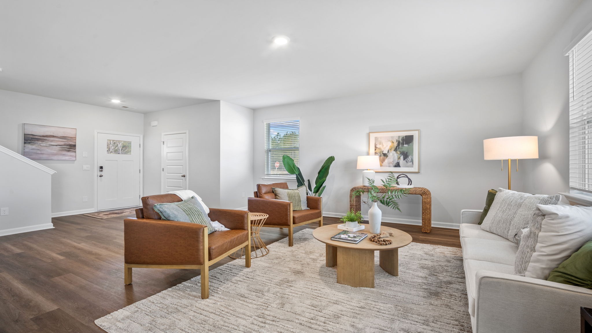 Living room view decorated with a couch, side tables and chairs