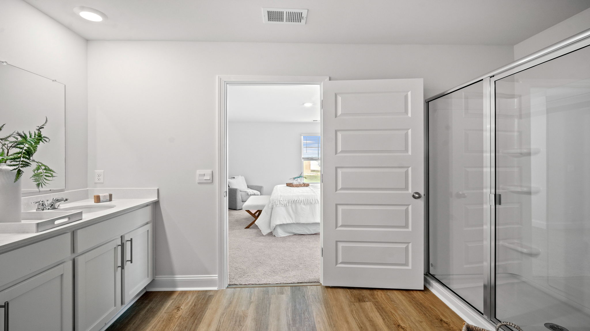Spacious bath with quality finishes, a large vanity area, and thoughtfully designed functionality.