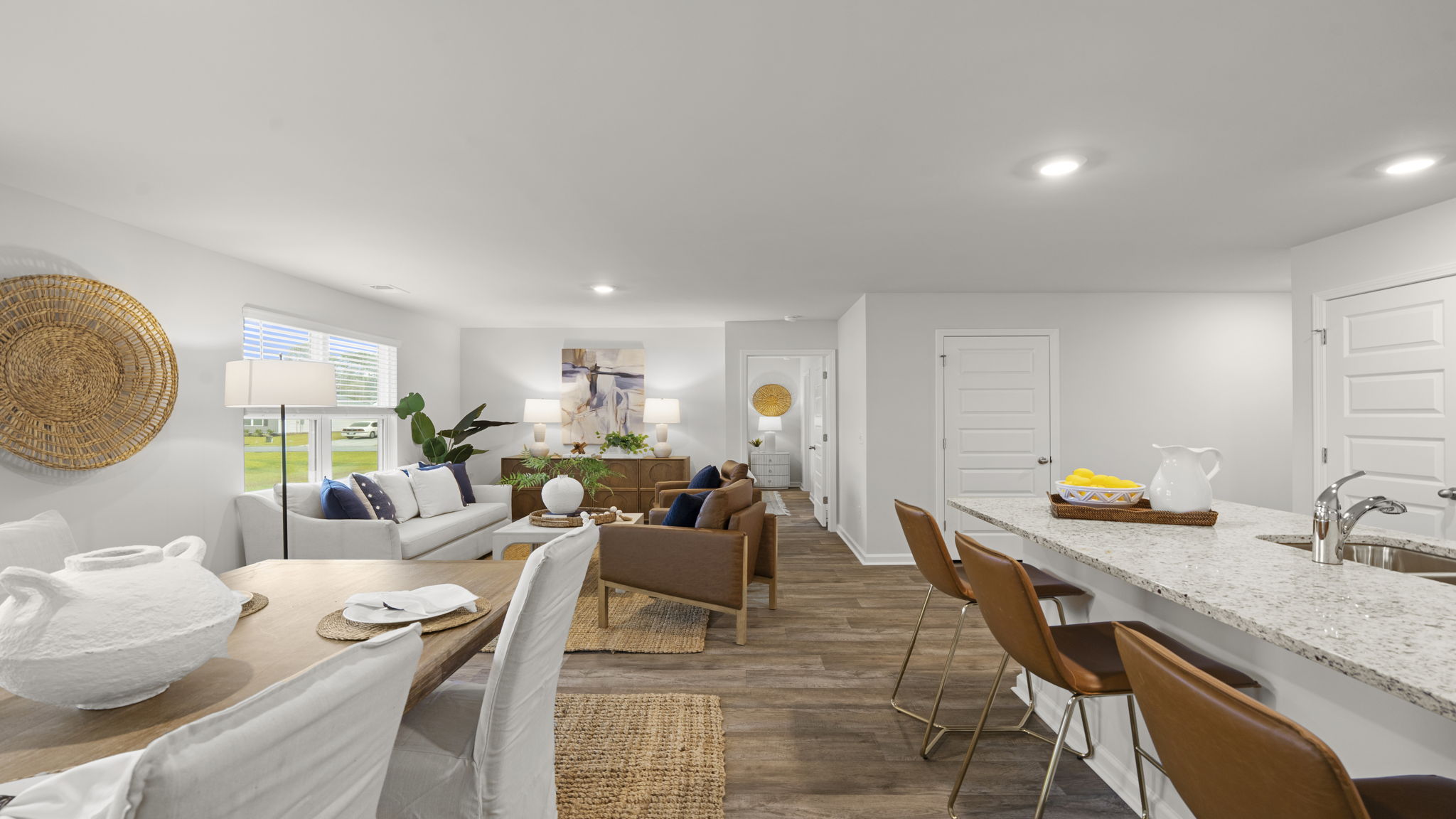 Bright open-concept living space with gourmet kitchen, dining area, spacious family room, and abundant natural light.