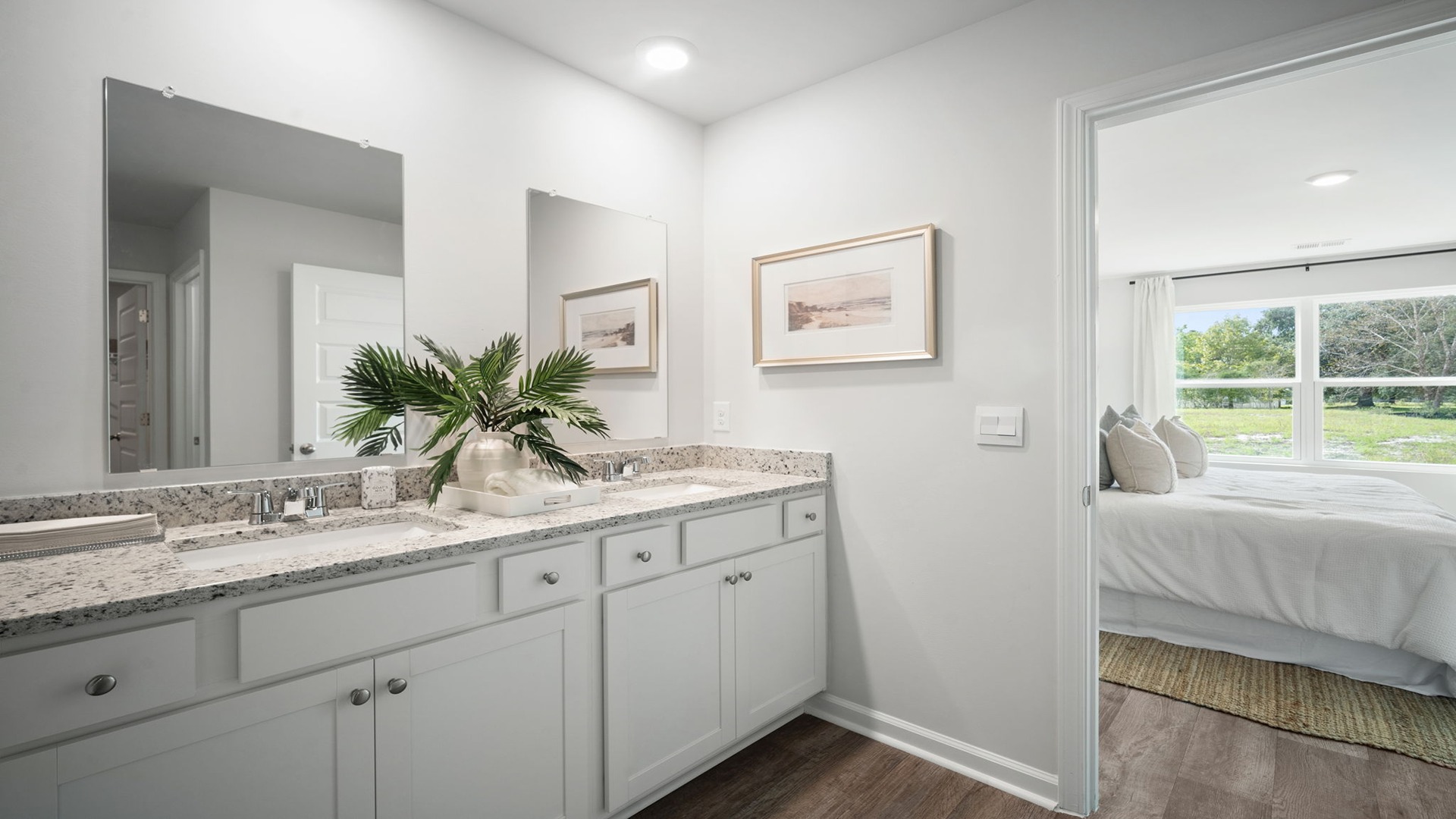 Primary bathroom with double vanities and a stand-up shower