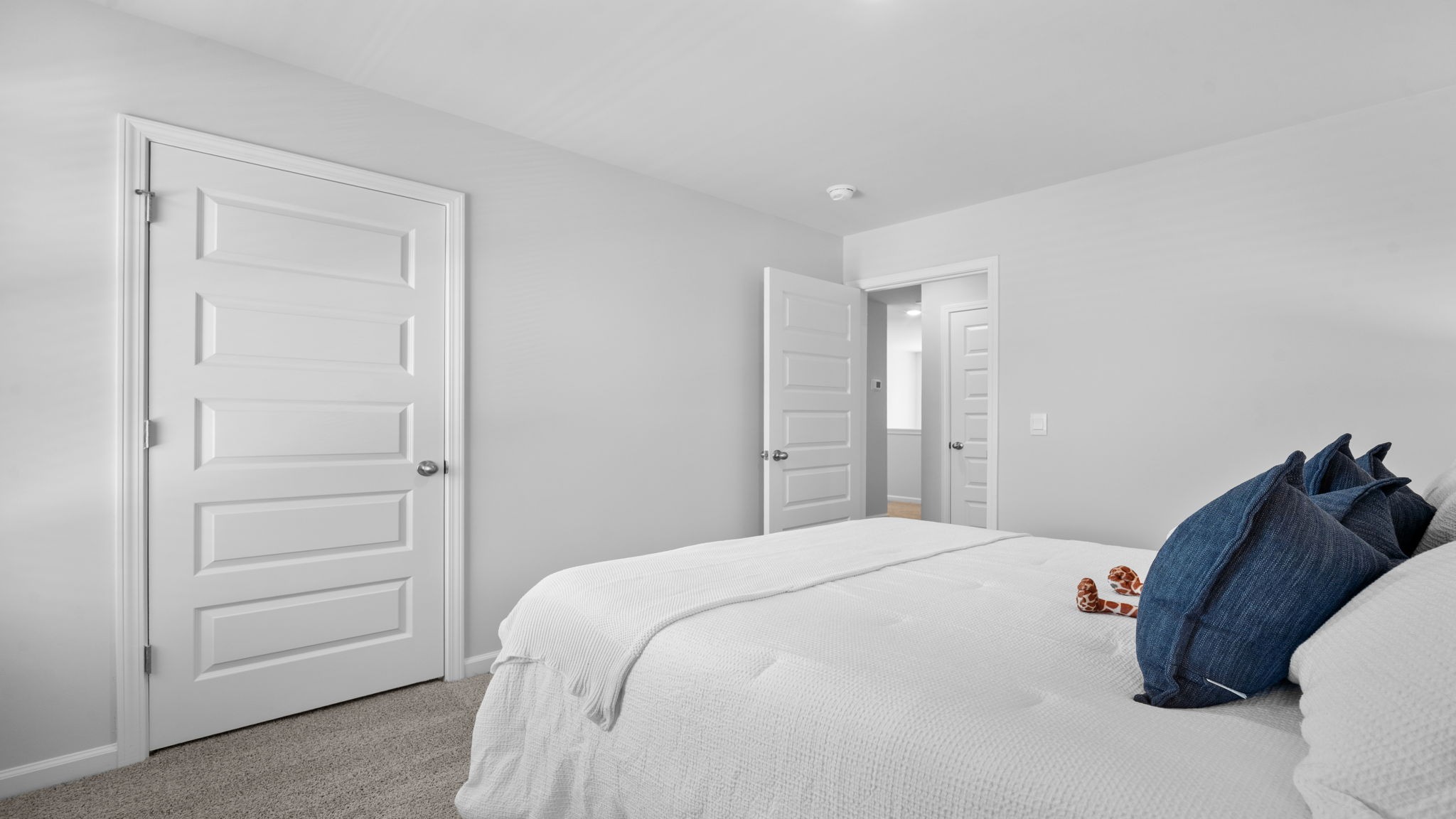 Guest bedroom decorated with a bed and a side table