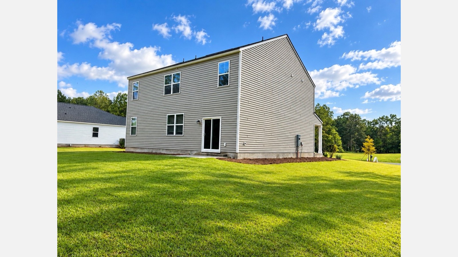 Hayden B Rear exterior of home with large side and back yard