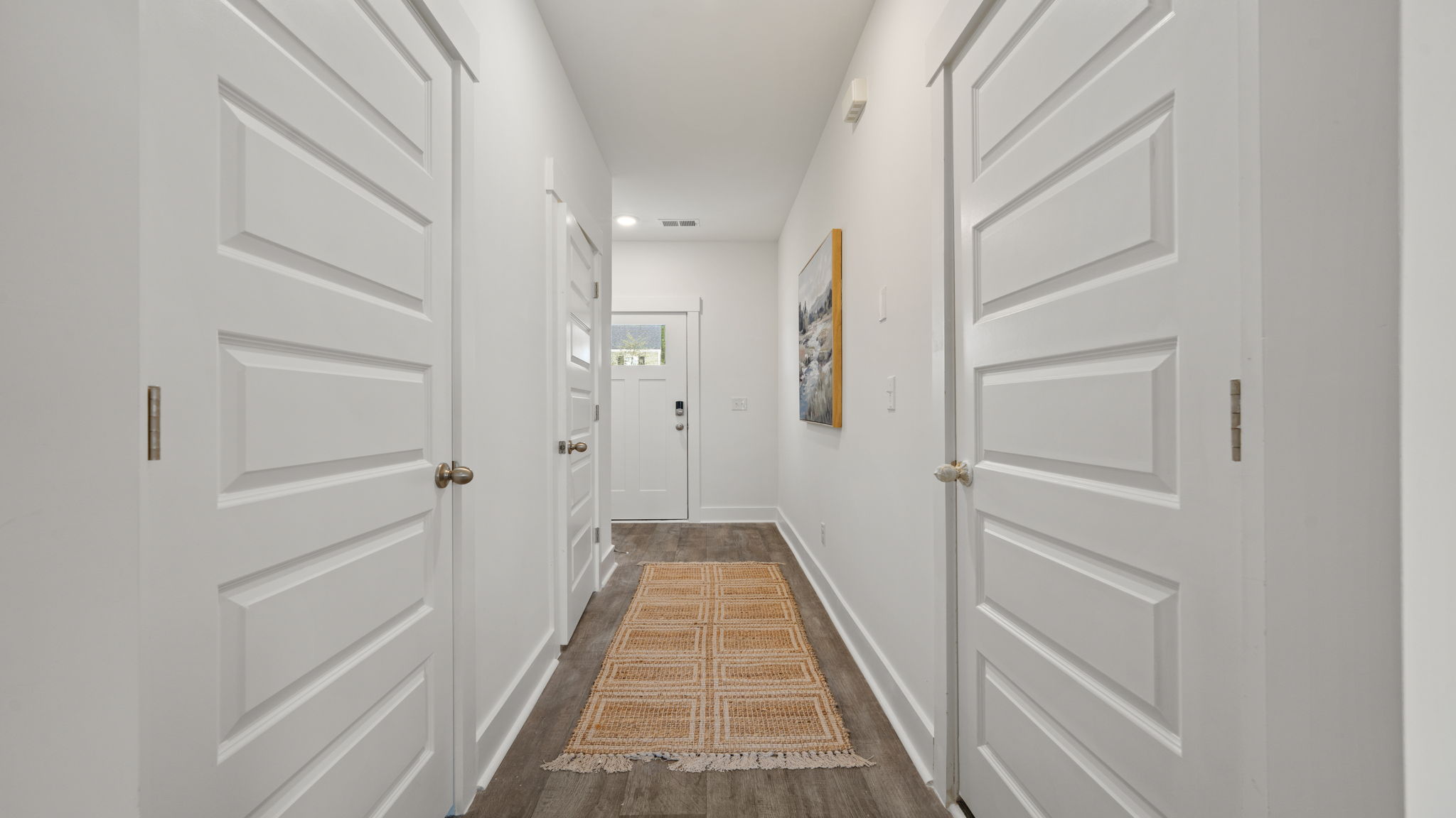 Entry hallway at 116 Chipmunk Trail featuring white interior doors and light flooring.