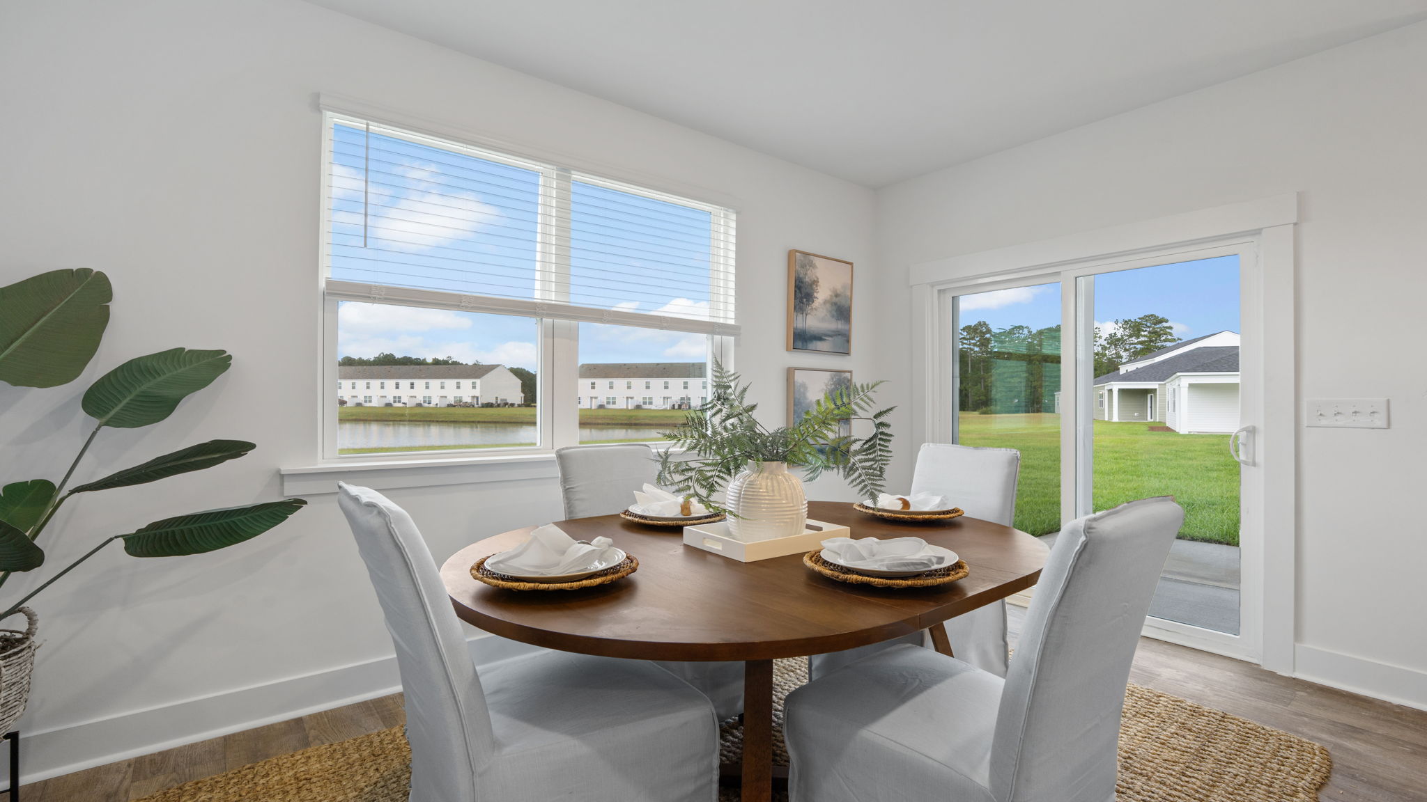 Dining area with large windows, natural light, and access to the backyard.