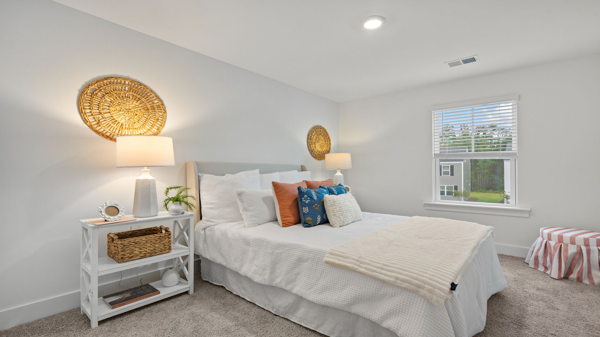 Bedroom with window, neutral carpet, and bright interior finishes.