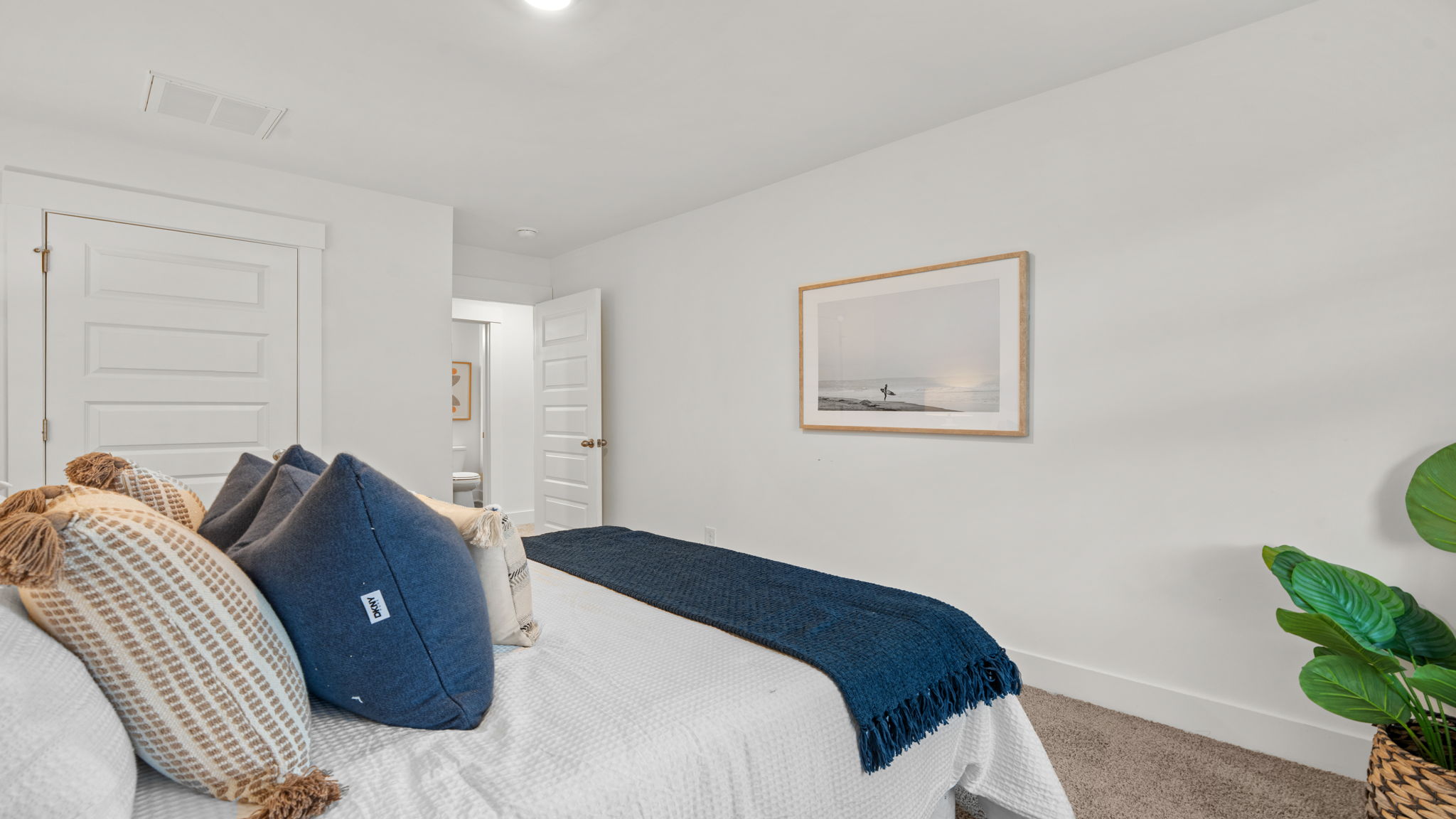 Bedroom featuring neutral carpeting, window, and bright interior finishes.