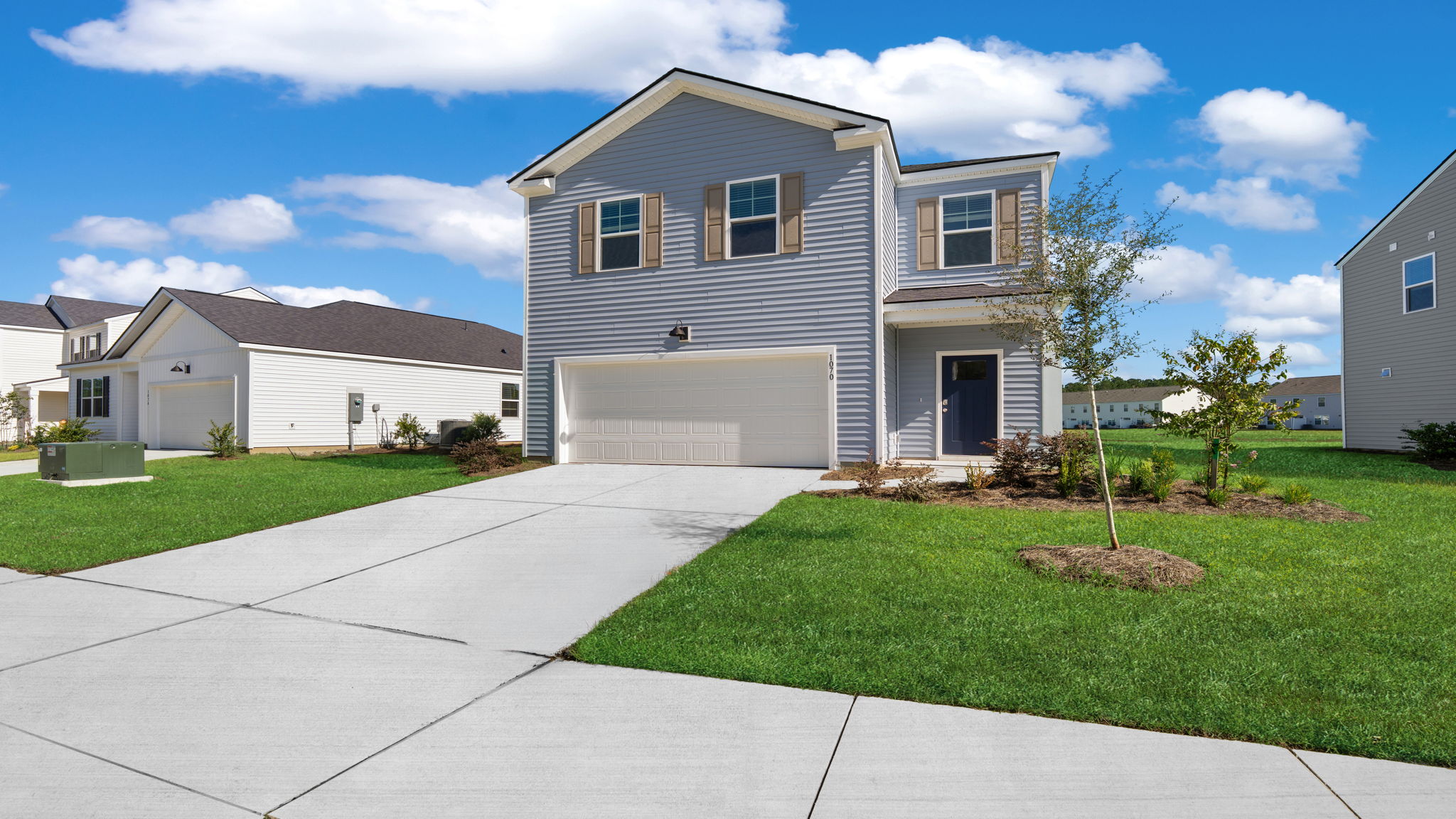 Front exterior of the two-story Cabral A at 116 Chipmunk Trail with attached garage, driveway, and front lawn.