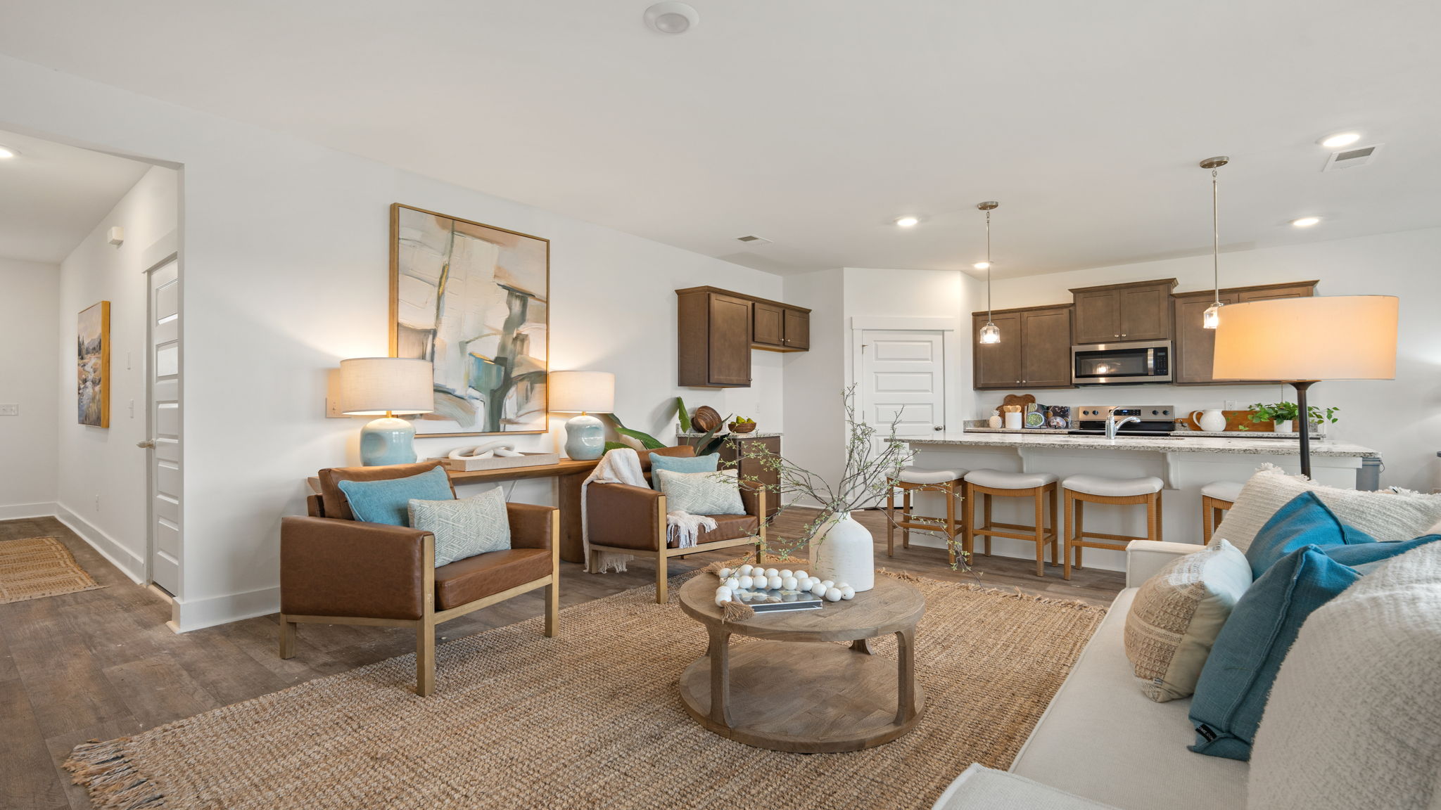 Spacious open-concept living and dining area with neutral finishes and comfortable seating.