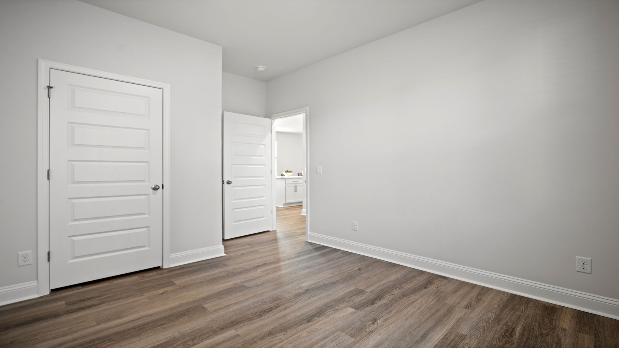 Bedroom with closet door and entry door.