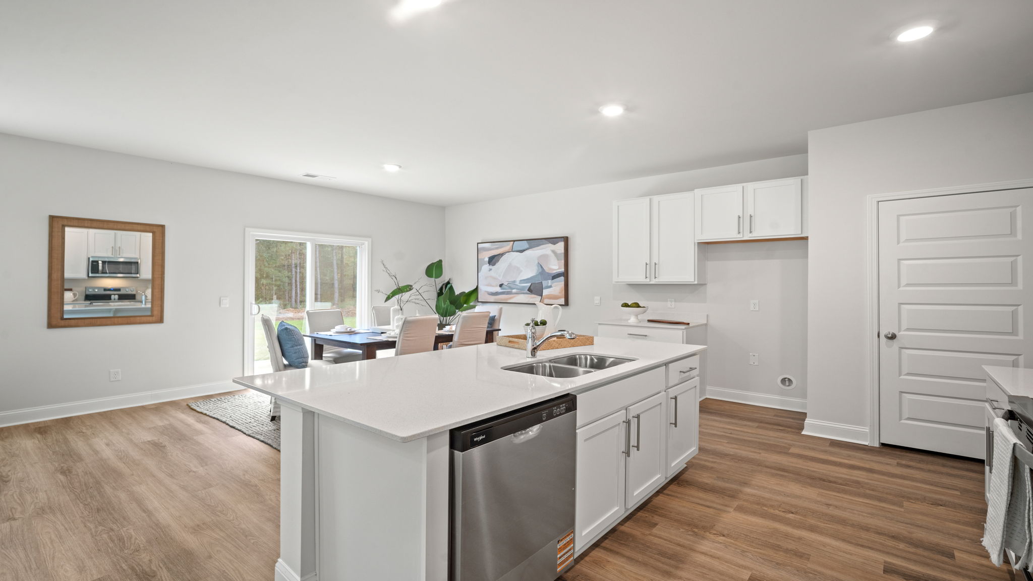 Open concept kitchen with view behind the island with living area.