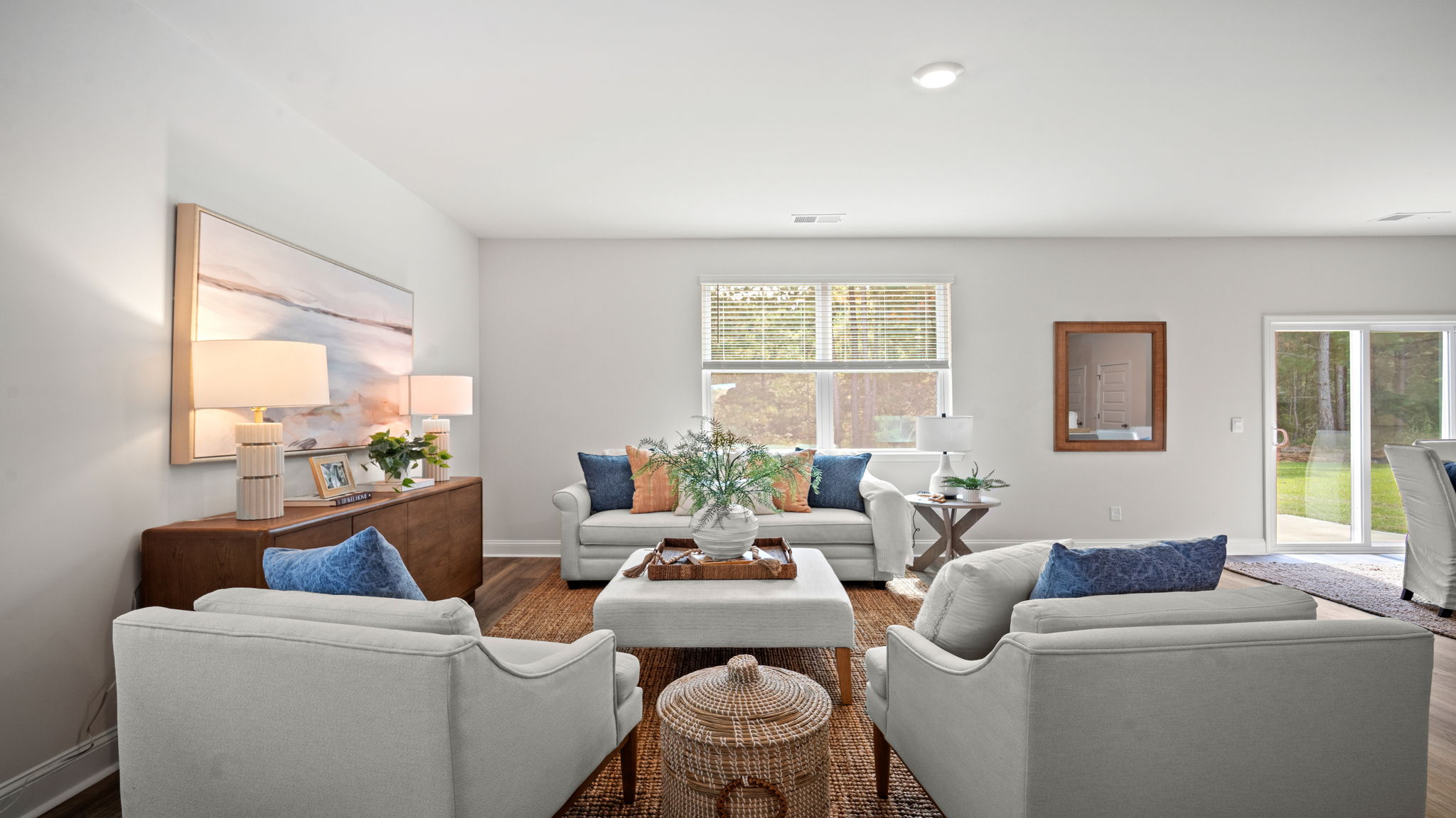 Living area with several large windows and glass back door to the back patio.