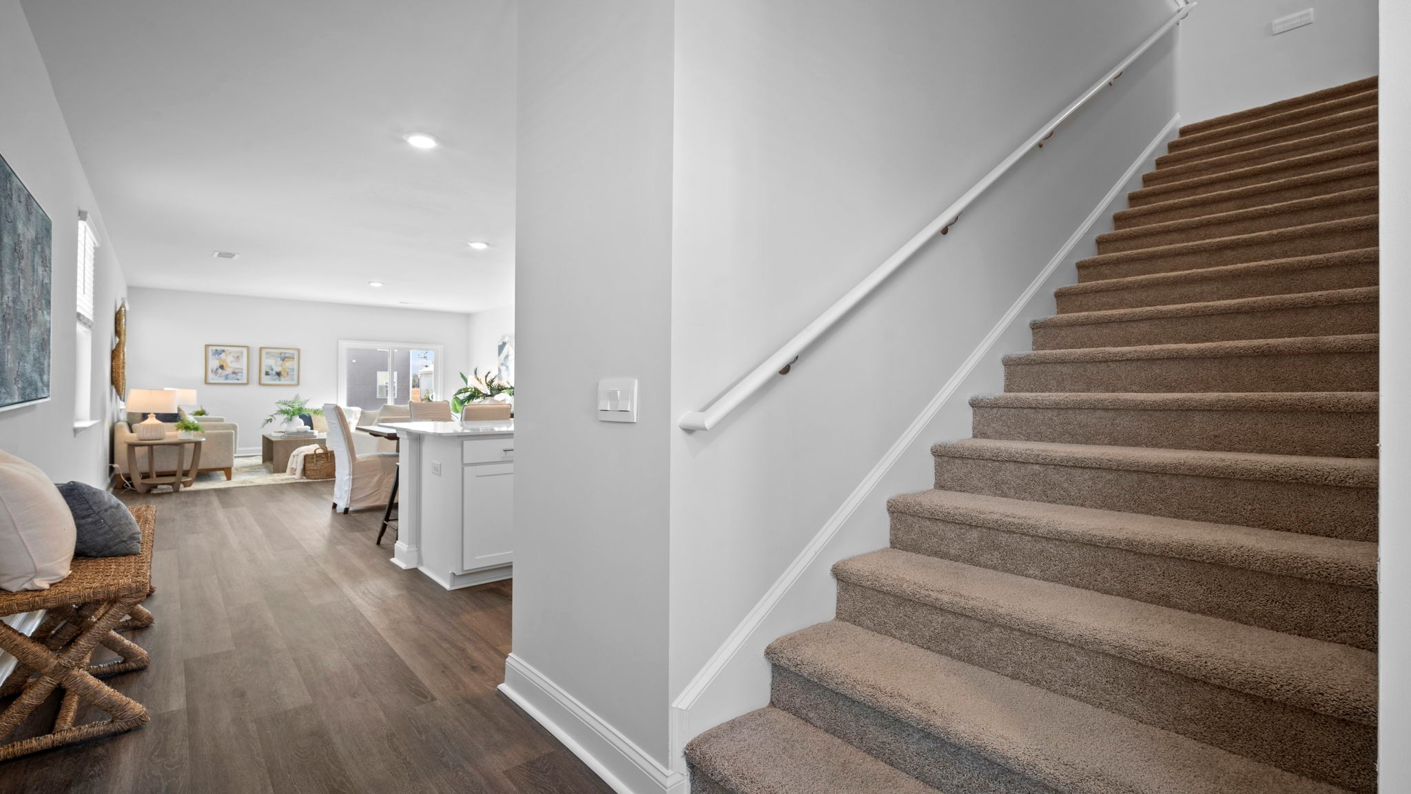 Staircase with living area behind