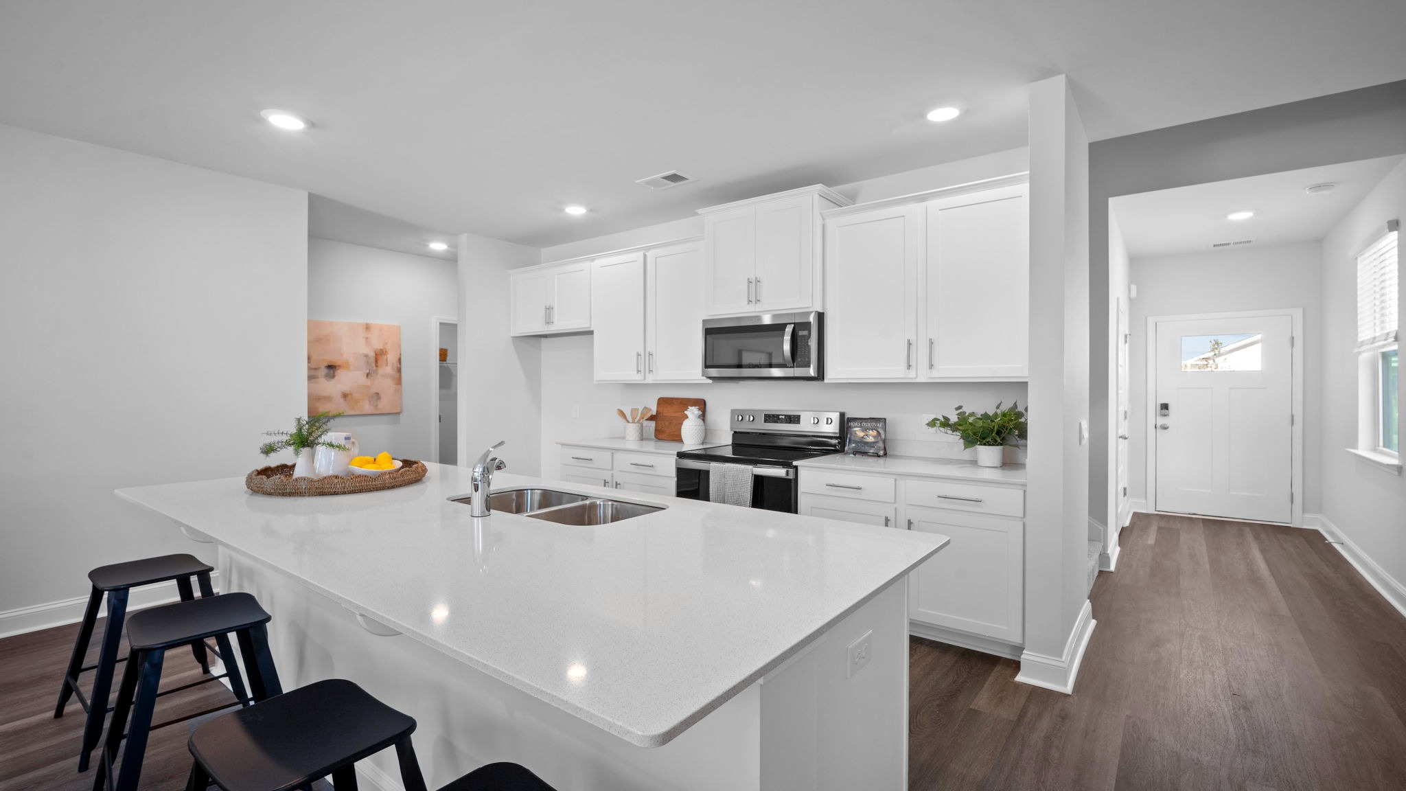 Kitchen island with view of the opposite counter and cabinets with an oven range