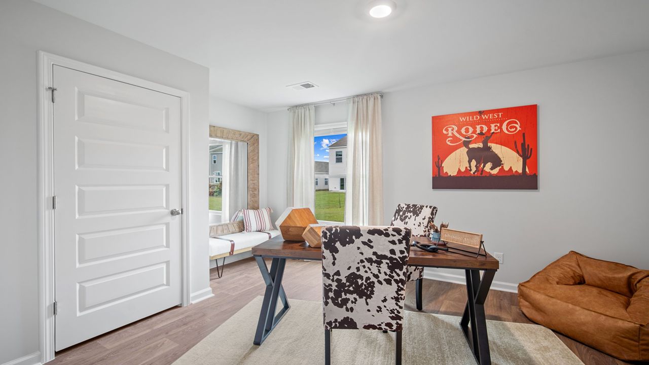Downstairs guest room decorated with a desk and chair