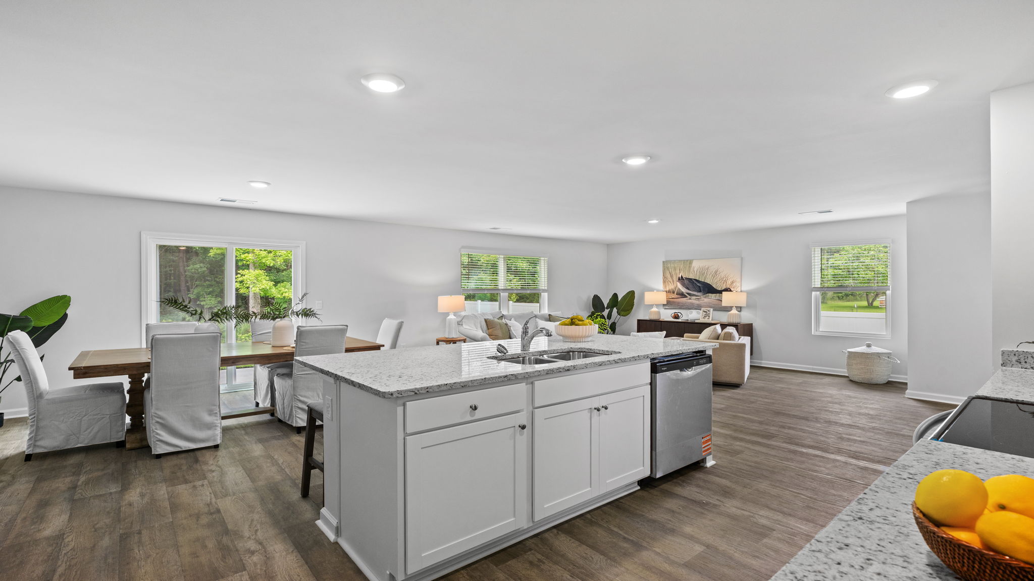Chef-inspired kitchen in the Downing floor plan by D.R. Horton in Rice Hope showcasing abundant cabinet storage, designer finishes, ample counter space, and seamless flow into the dining and living areas.