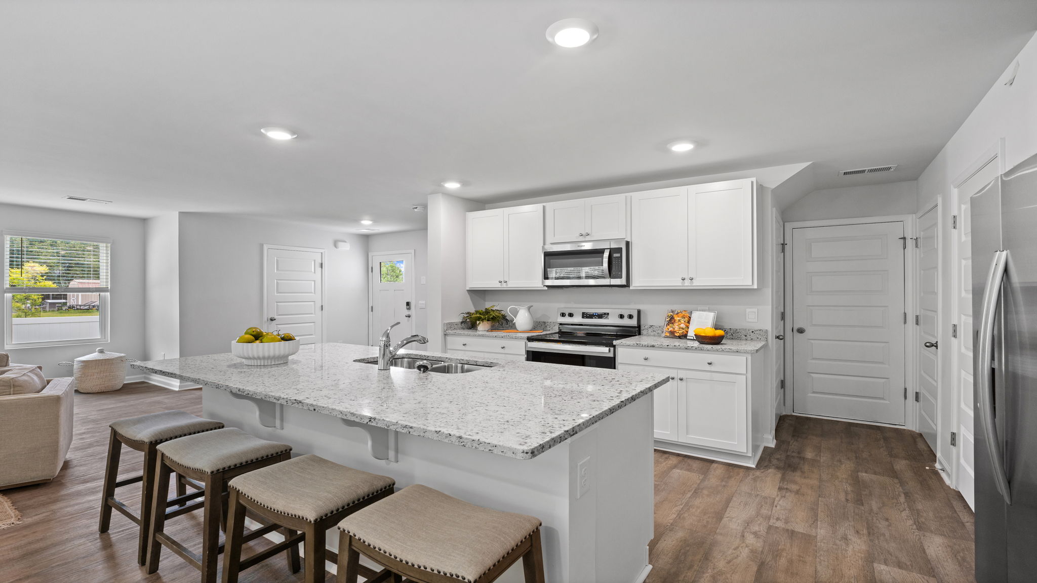 Beautiful kitchen in the Downing floor plan at Rice Hope by D.R. Horton featuring granite countertops, stainless steel appliances, modern cabinetry, a spacious center island, and an open-concept layout designed for entertaining and everyday living.