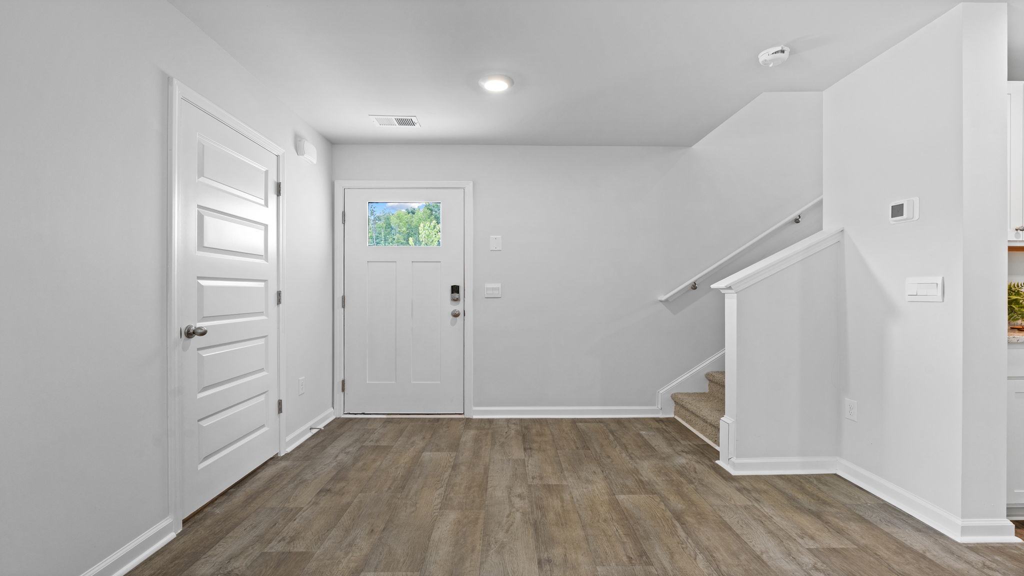 Welcoming foyer in the Downing floor plan at Rice Hope by D.R. Horton featuring open sightlines, natural light, modern finishes, and seamless flow into the home's main living areas.