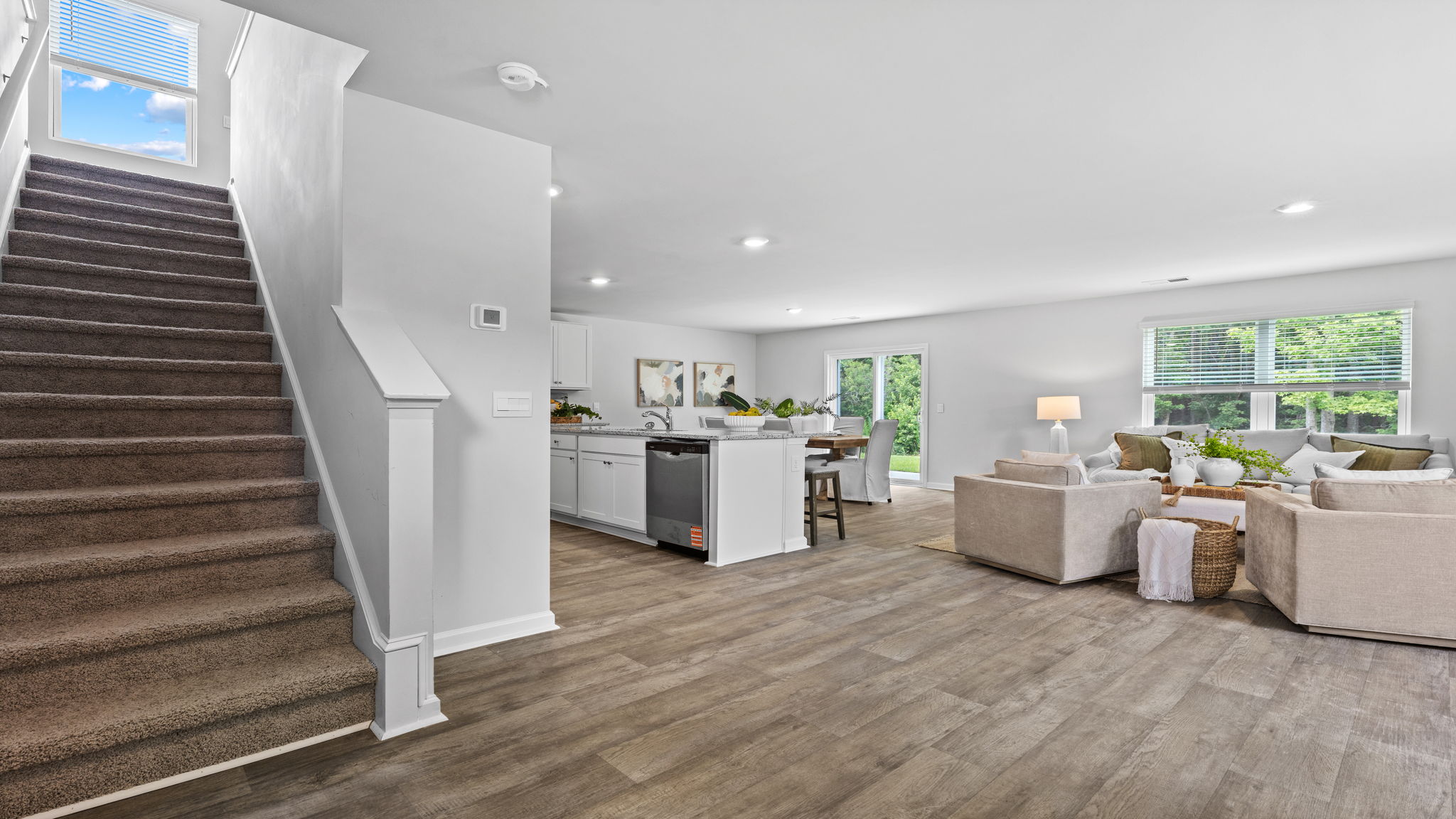 Bright entryway in the Downing floor plan showcasing contemporary flooring, spacious design, and an inviting first impression for homeowners and guests