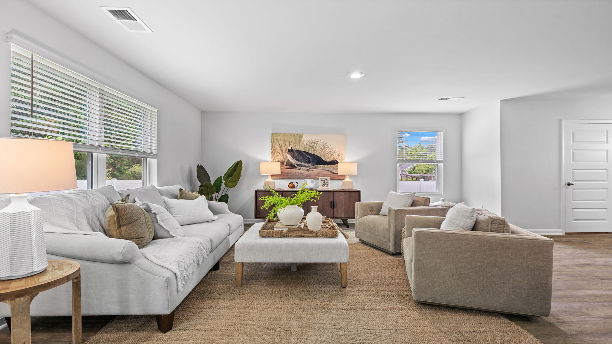 Bright open-concept living area in the Downing floor plan at Rice Hope featuring expansive sightlines, contemporary design, and versatile space for gathering with family and friends.
