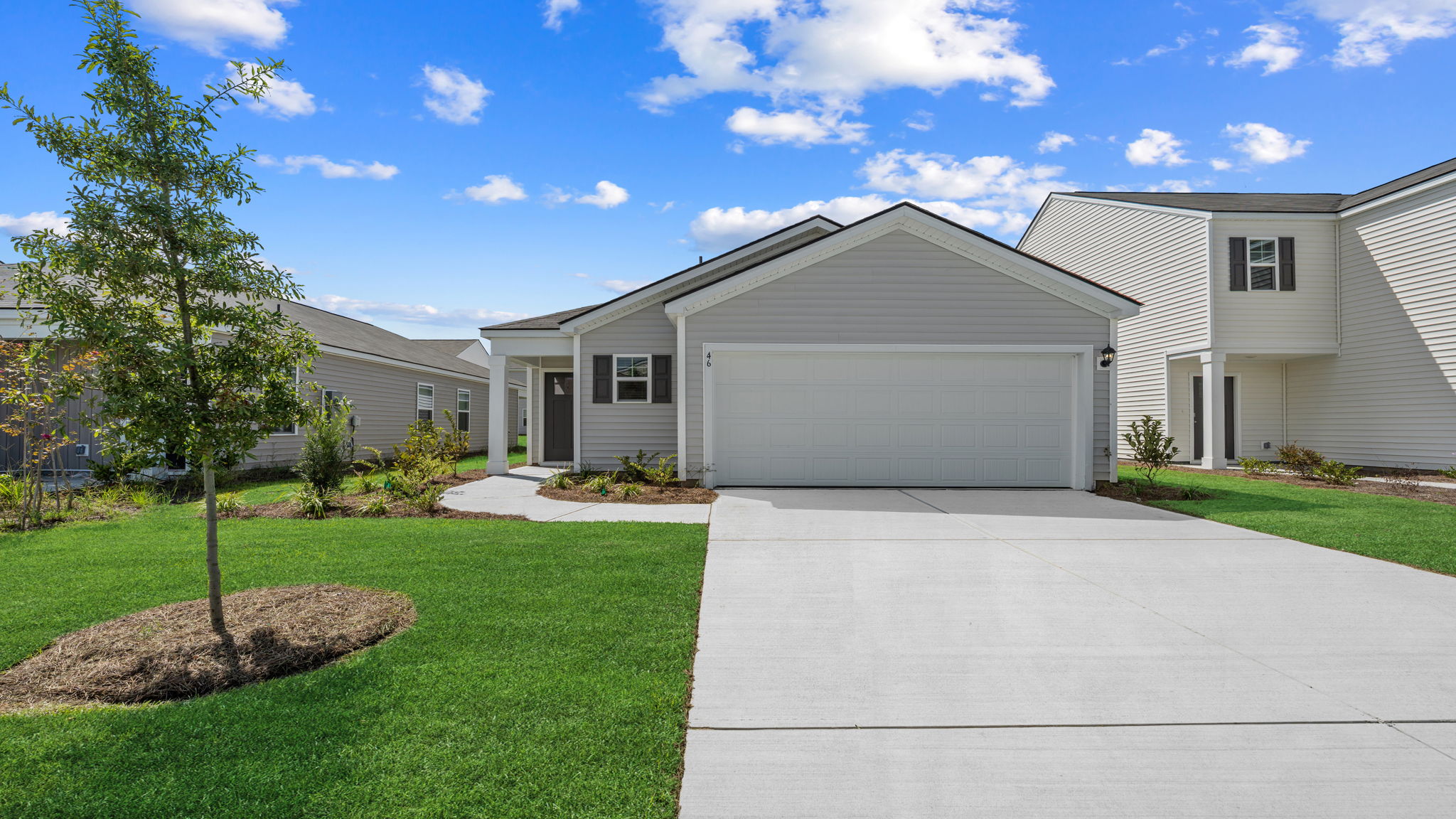 Allex A Front Exterior | Single-story home with attached garage, front lawn, and driveway in Rice hope