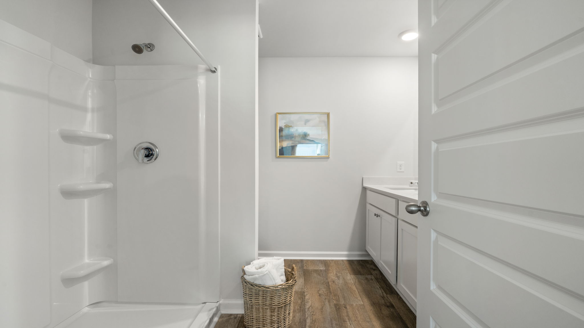 Allex A Primary Bathroom | Primary bath featuring dual vanities and modern fixtures.