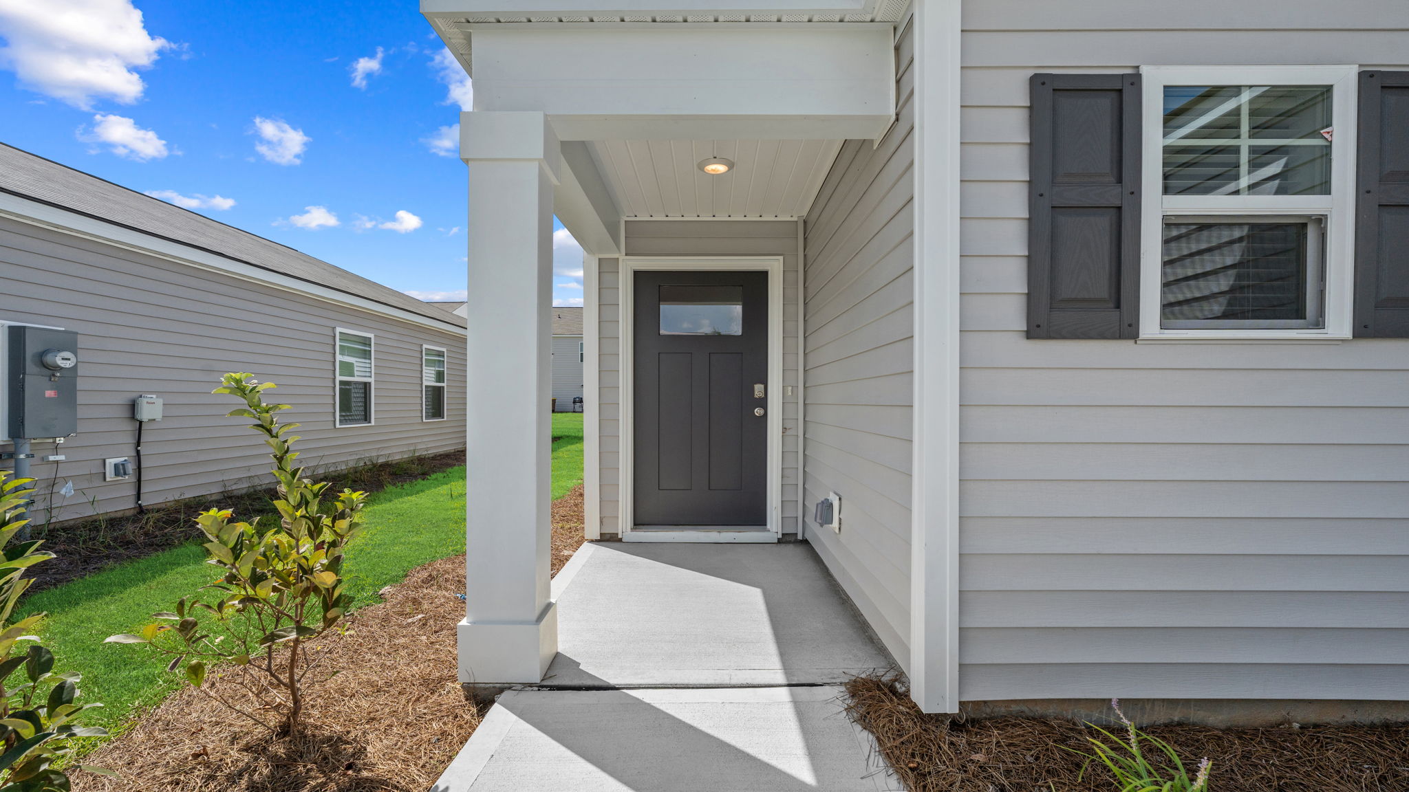 Allex A Covered Front Porch | Covered entry porch offering curb appeal and outdoor seating potential.