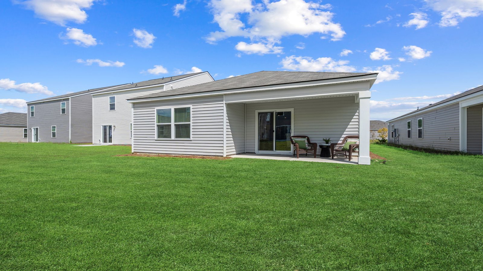 Allex A Backyard Exterior | Rear exterior view showcasing covered patio and backyard space.