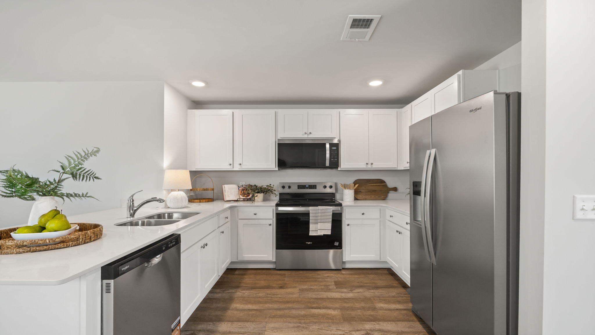 Allex A Kitchen | Modern kitchen with center island, stainless steel appliances, and open layout.