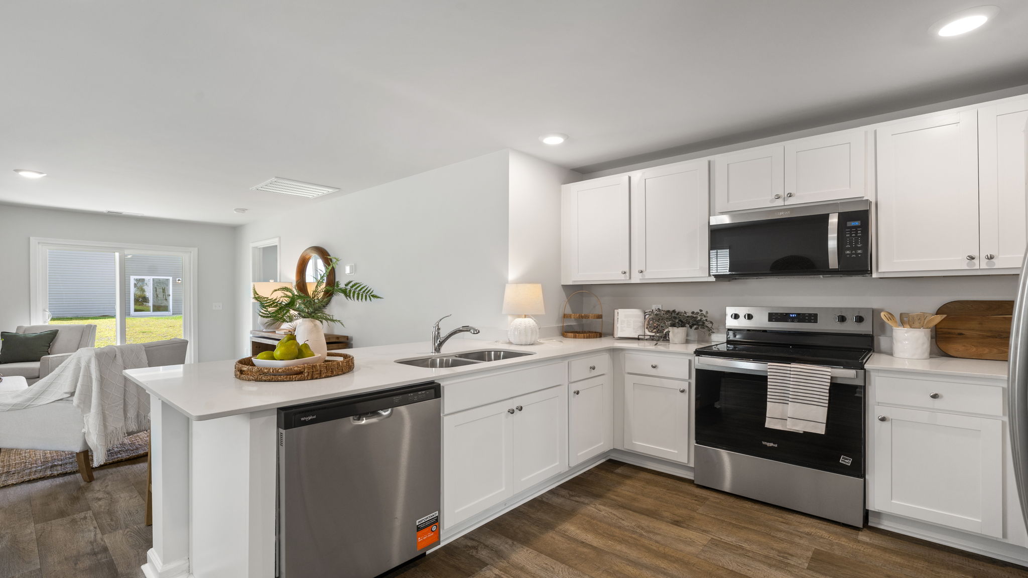 Allex A Kitchen Alternate View | Bright kitchen featuring island seating and ample cabinet storage.