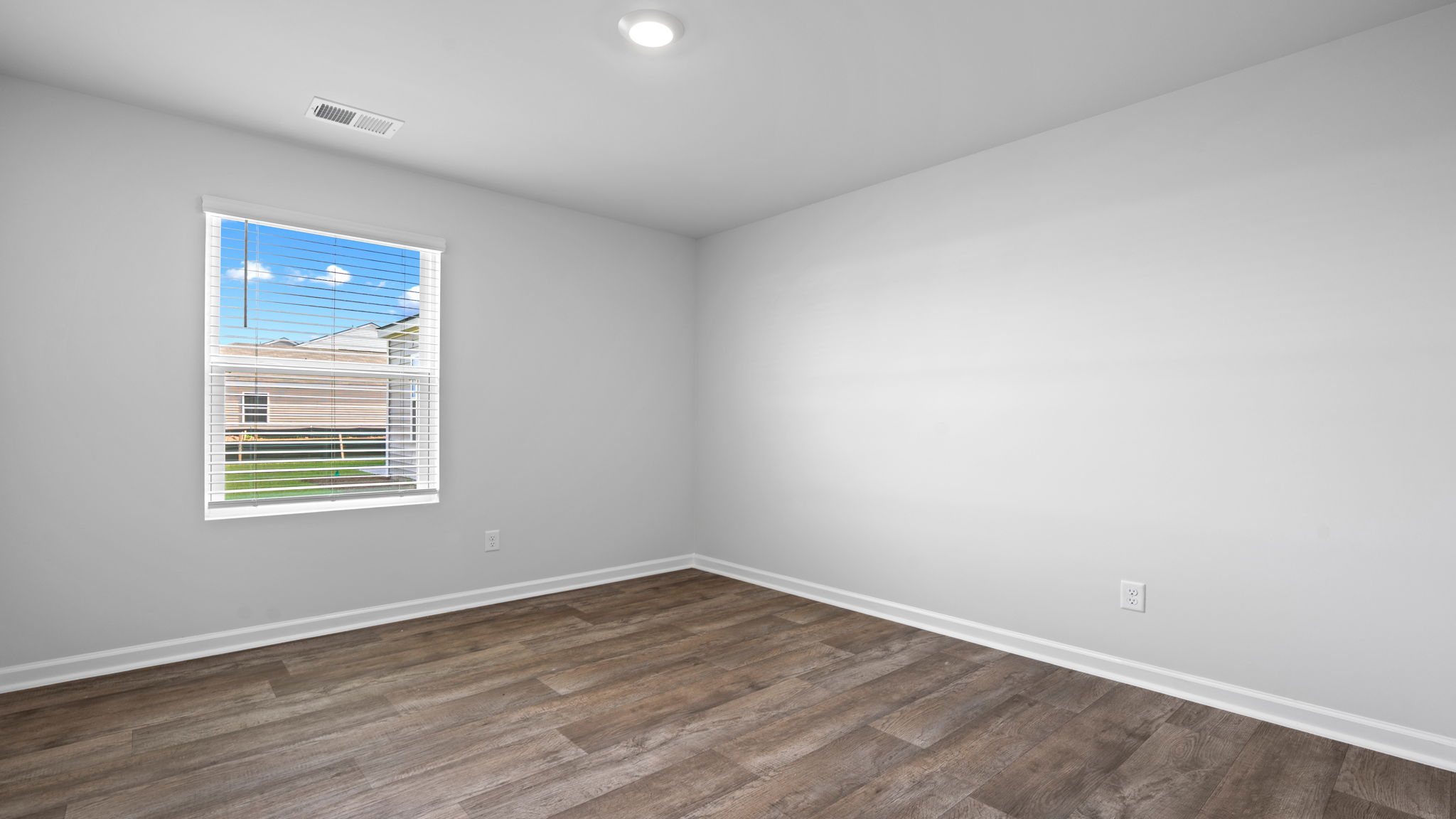Versatile secondary bedroom in the Willow floor plan ideal for guests, children, or a home office with bright natural light and ample closet space.