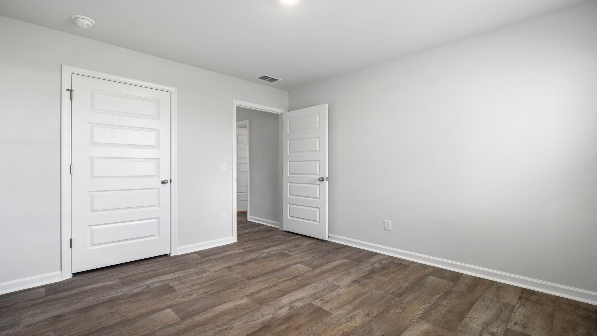 Comfortable guest bedroom in the Willow home featuring modern finishes and flexible living options.