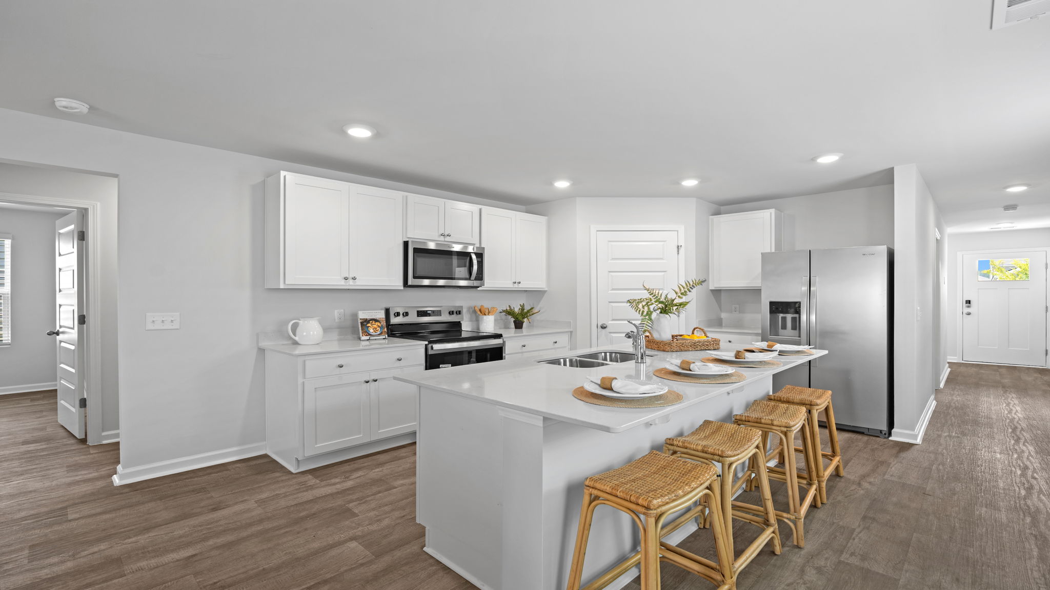Modern kitchen in the Willow by D.R. Horton featuring ample counter space, cabinetry, and views of the open living area.