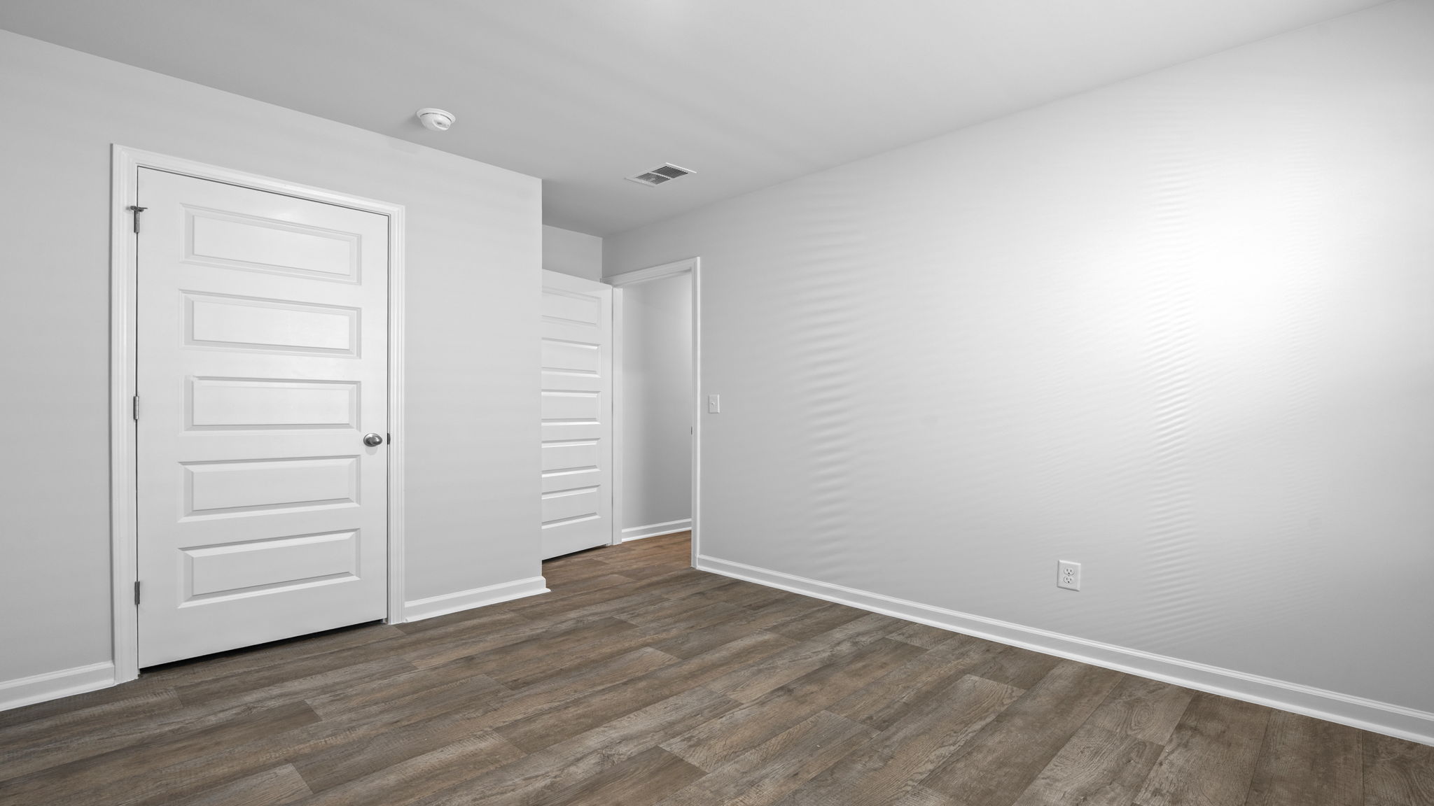 Versatile secondary bedroom in the Willow floor plan suitable for guests, family members, or workspace needs.