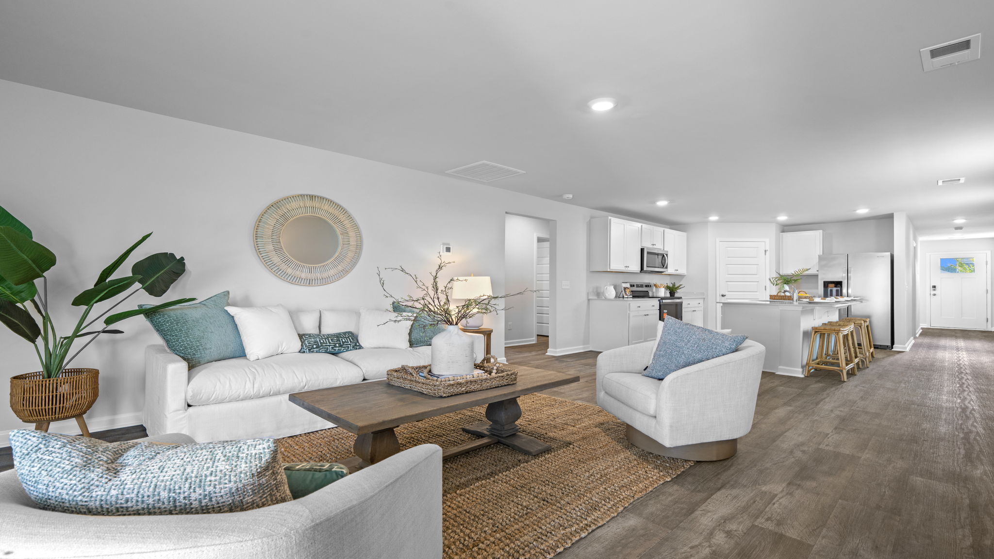 Open-concept living room in the Willow floor plan by D.R. Horton with spacious layout and seamless flow to the kitchen and dining area.