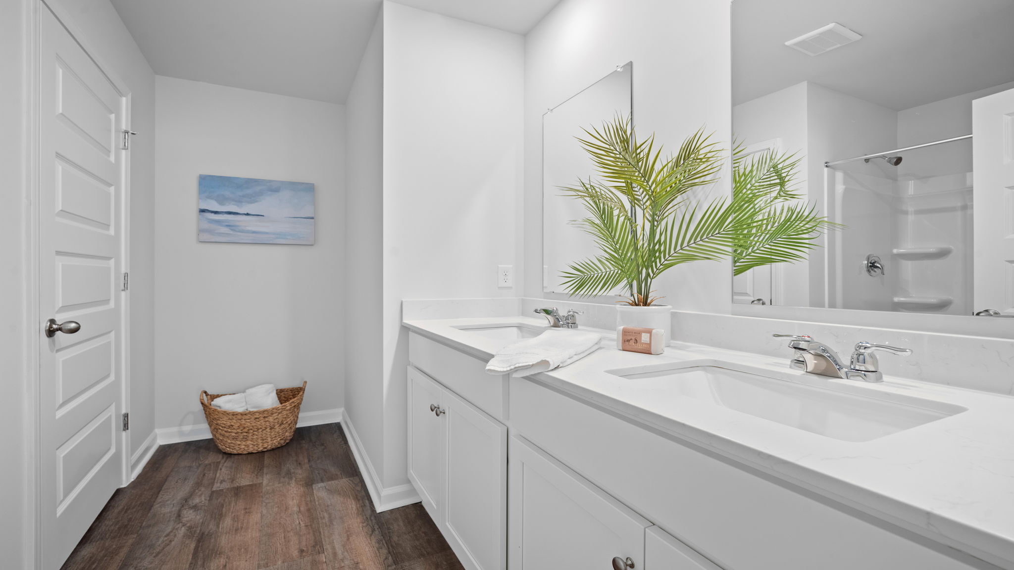 Primary bathroom with vanity and shower area.
