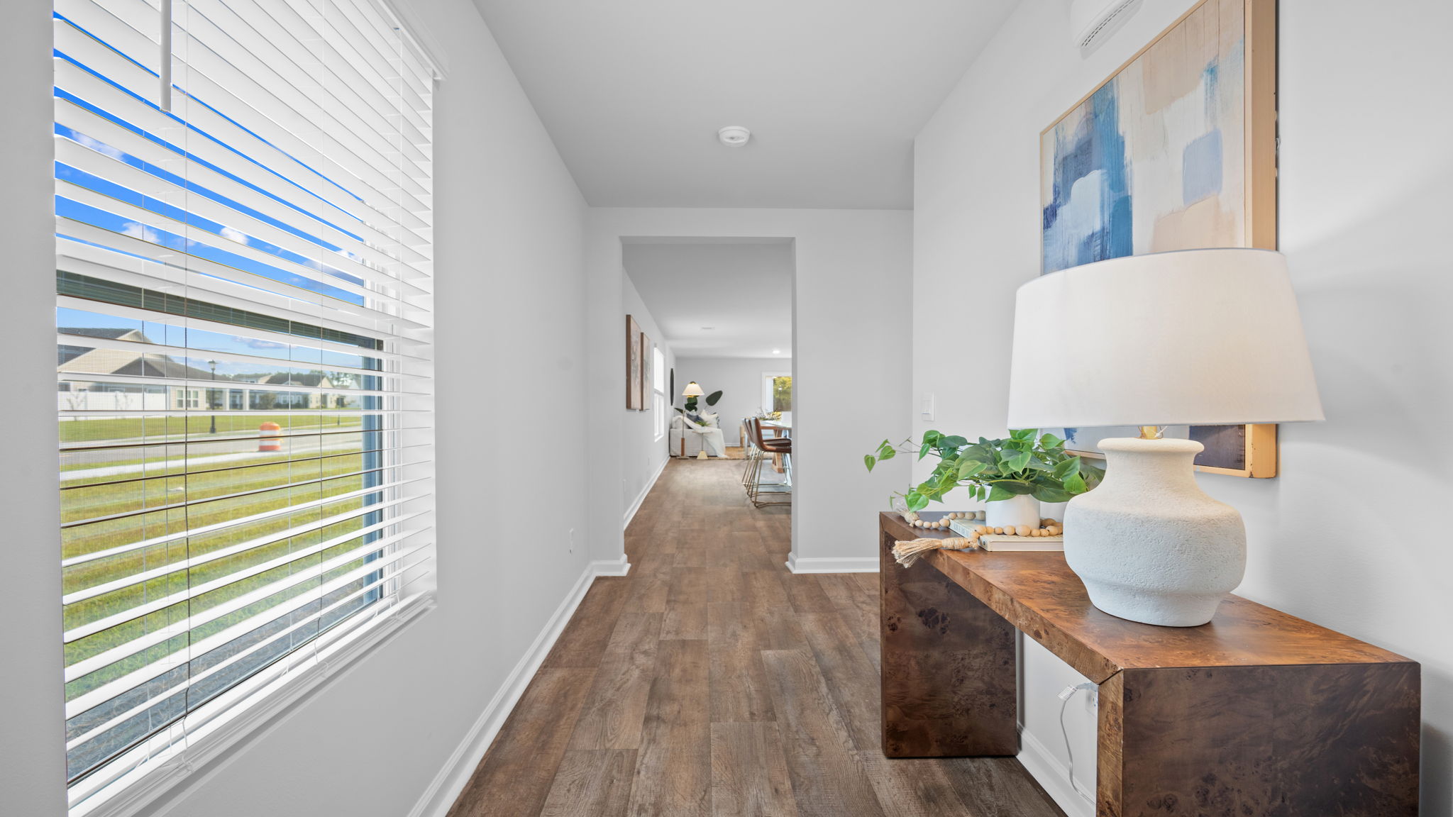 Home foyer with flooring and natural light.