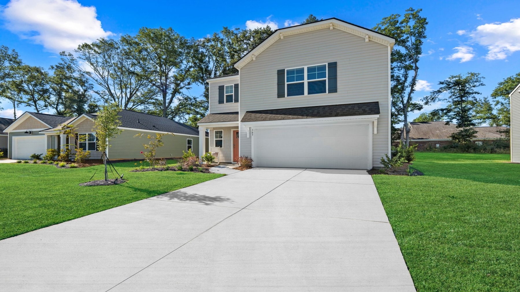 Angled front exterior view of the Darwin floorplan featuring a two-story elevation, attached garage, and spacious front lawn.
