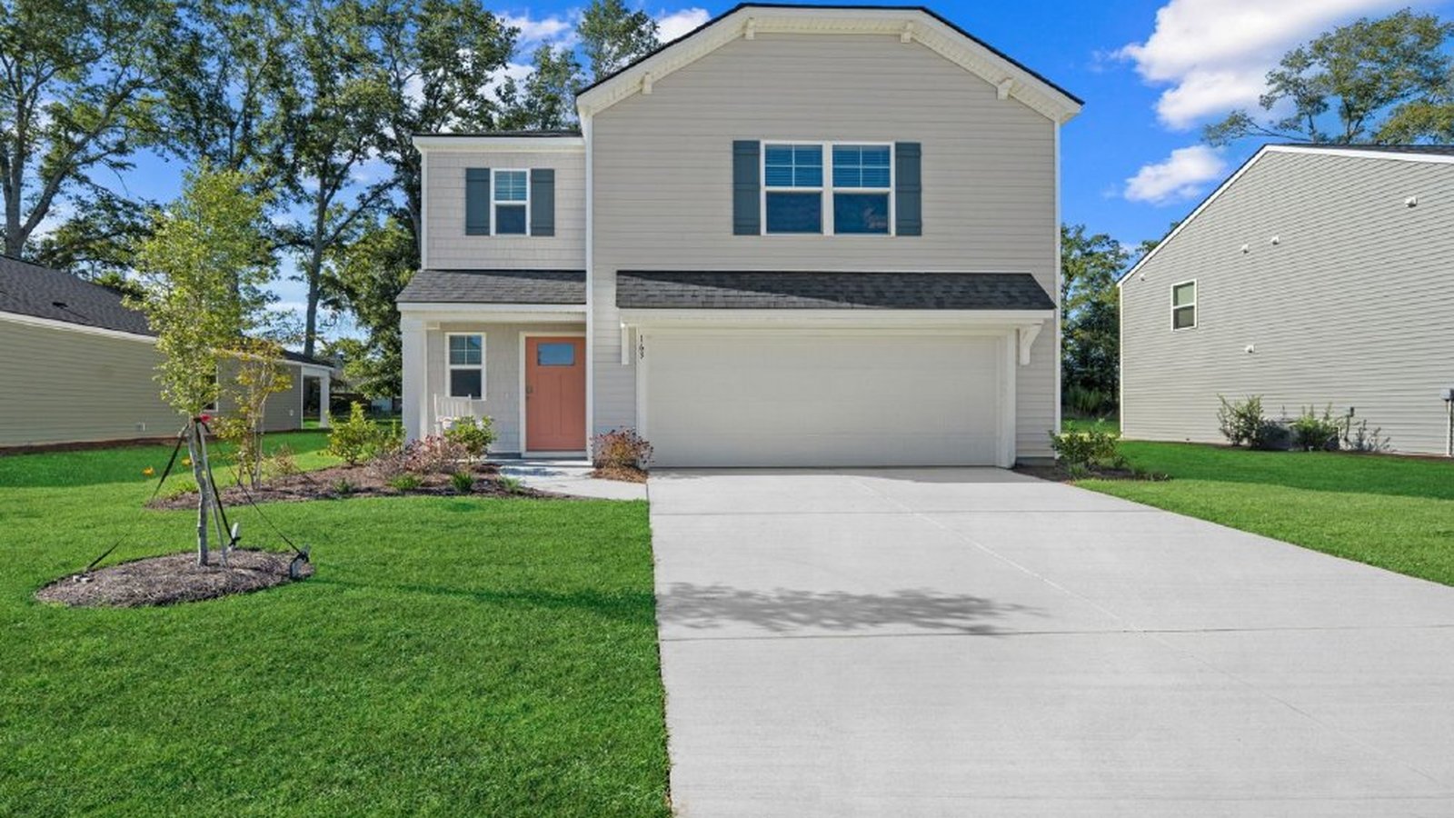 Darwin B Front exterior perspective of the Darwin home highlighting the attached garage, landscaped entry, and large homesite
