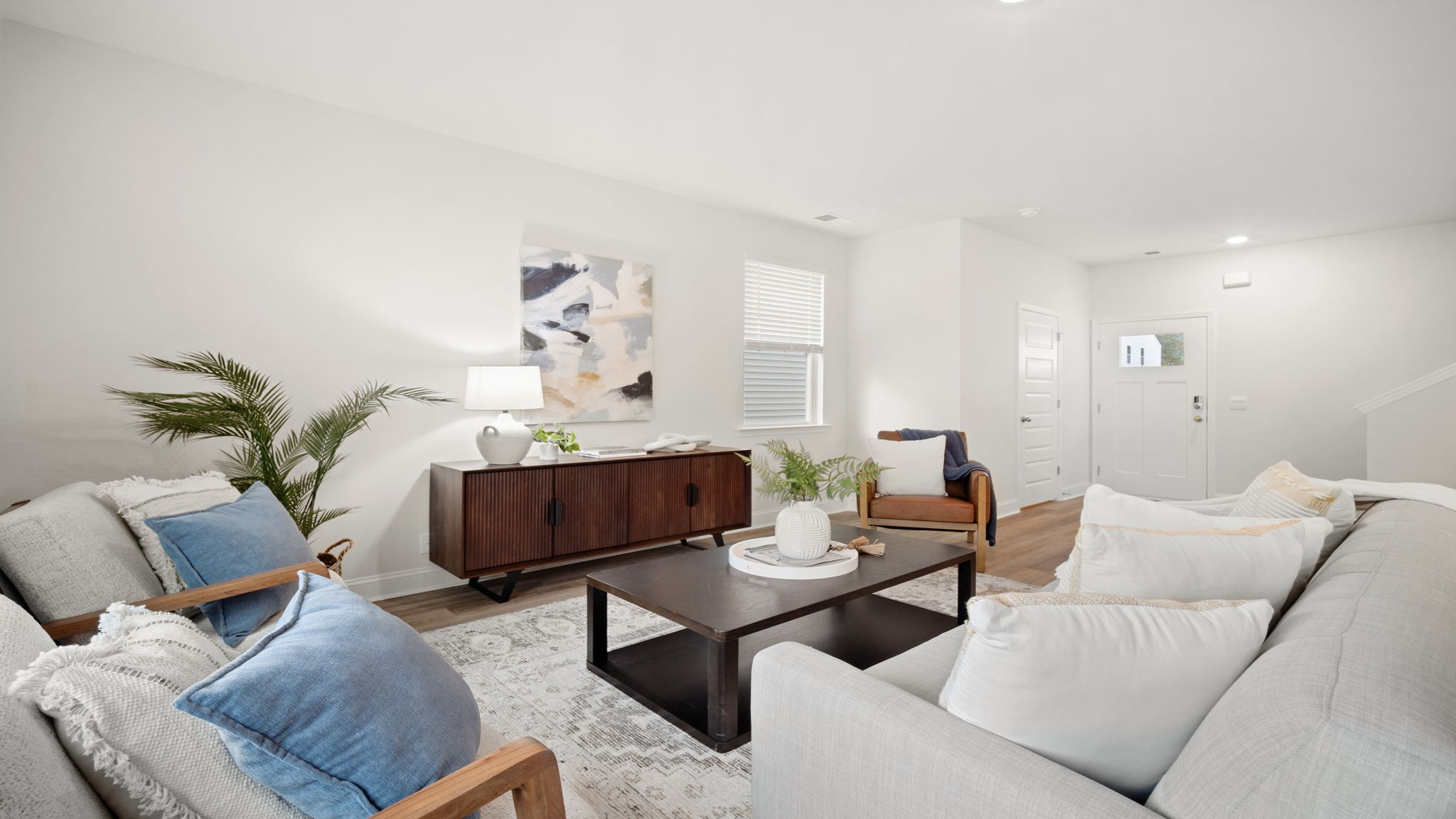 Elegant family room in the Belhaven floorplan showcasing comfortable gathering space, contemporary design elements, and seamless connectivity to the kitchen and dining areas.