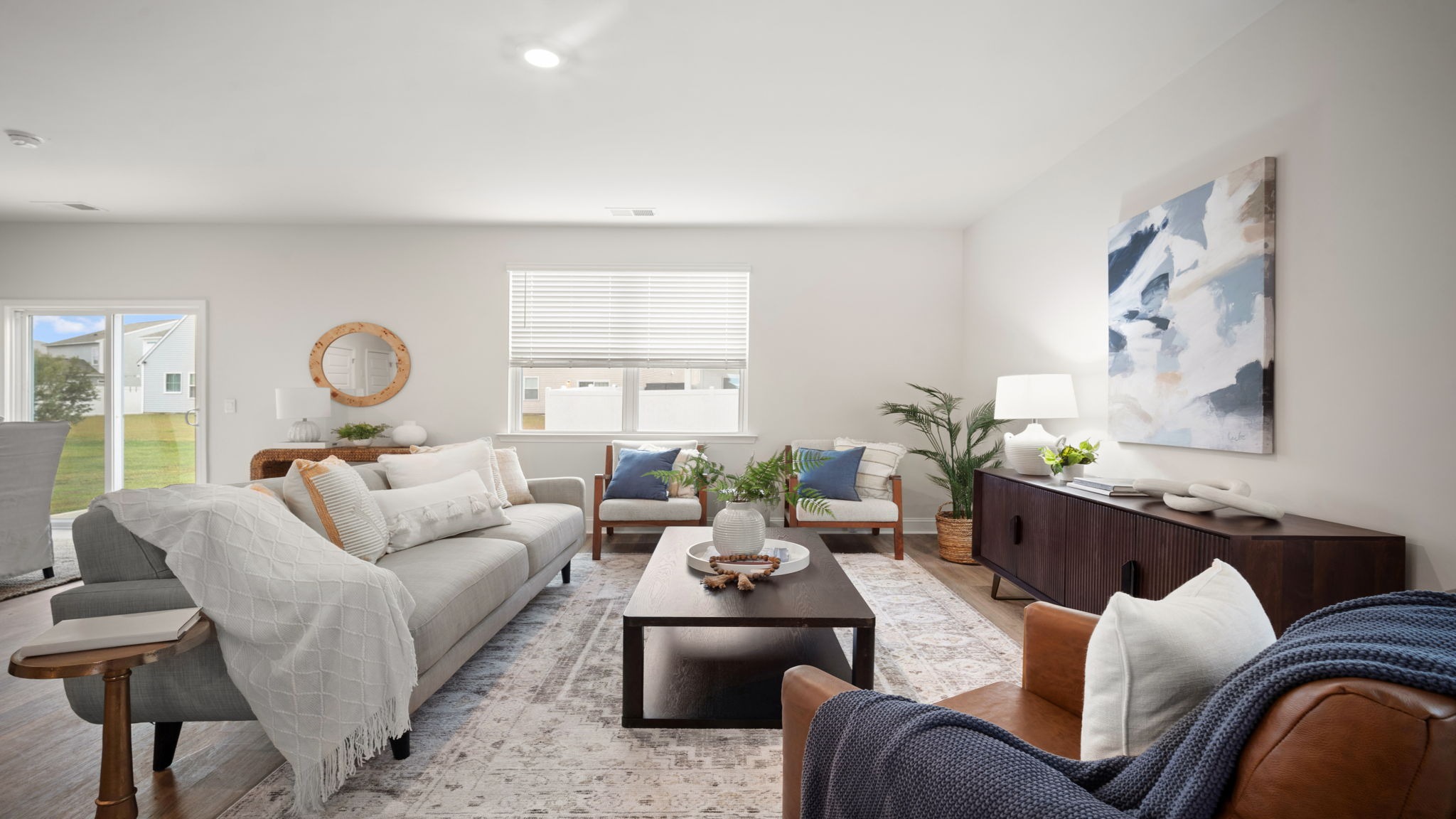 Bright open living area in the Belhaven by D.R. Horton featuring airy interiors, designer finishes, and flexible space perfect for entertaining guests.