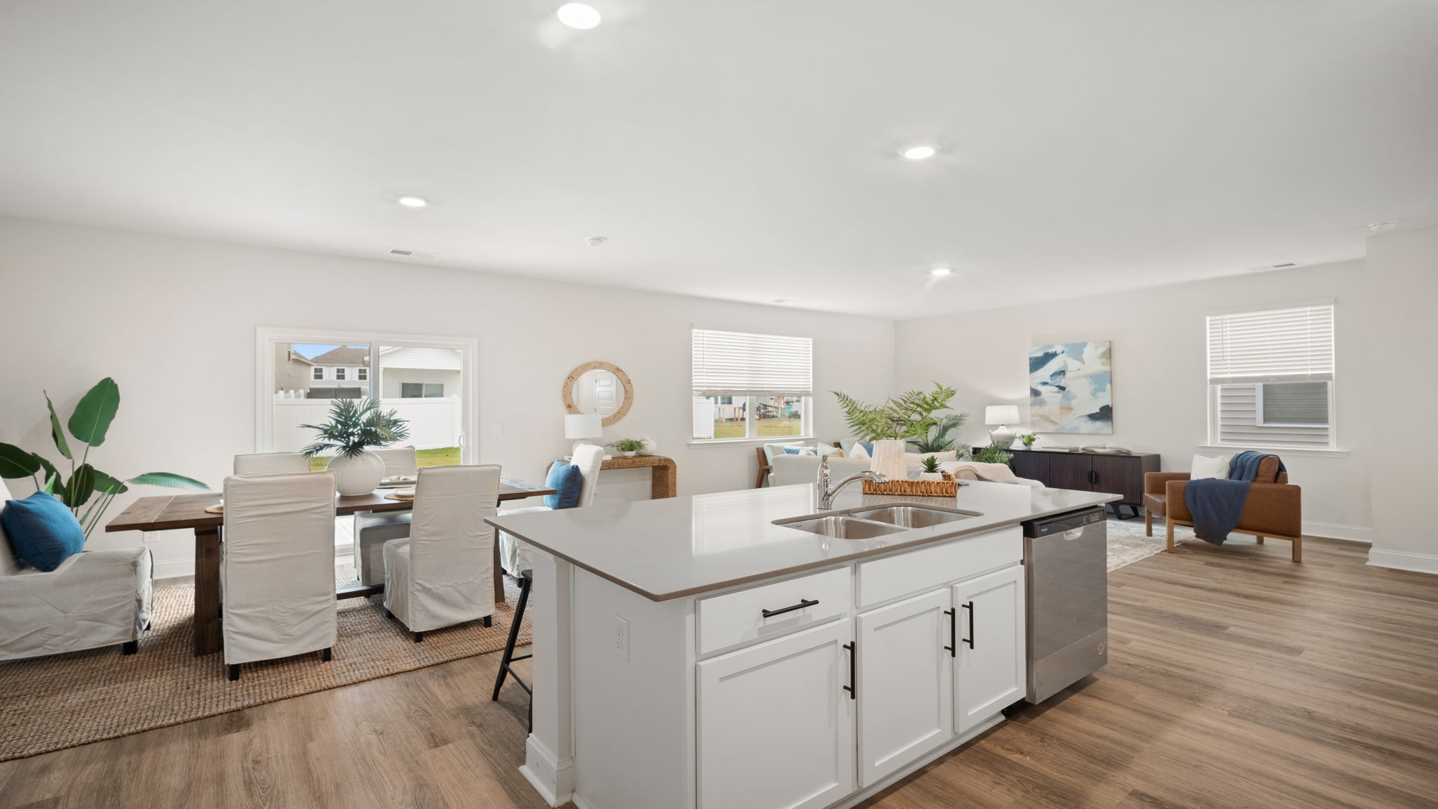 Open-concept kitchen with oversized island in the Belhaven floorplan featuring natural light, energy-efficient appliances, stylish fixtures, and functional space for everyday living.