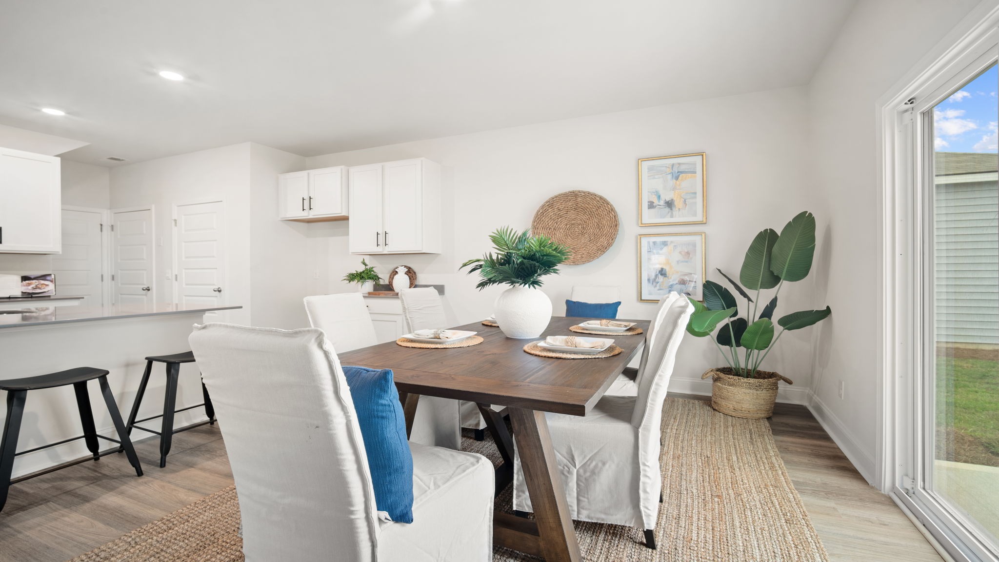 Elegant dining space in the Belhaven by D.R. Horton featuring contemporary design, stylish fixtures, and a seamless transition between living areas.