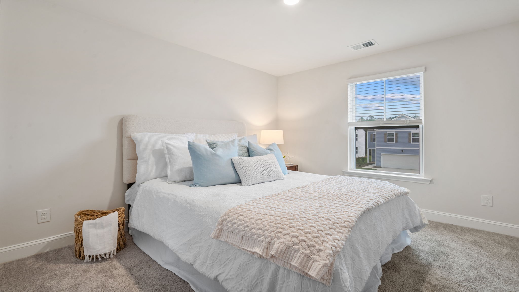 Comfortable guest bedroom in the Belhaven floorplan by D.R. Horton featuring natural light, spacious accommodations, modern finishes, and versatile living space.