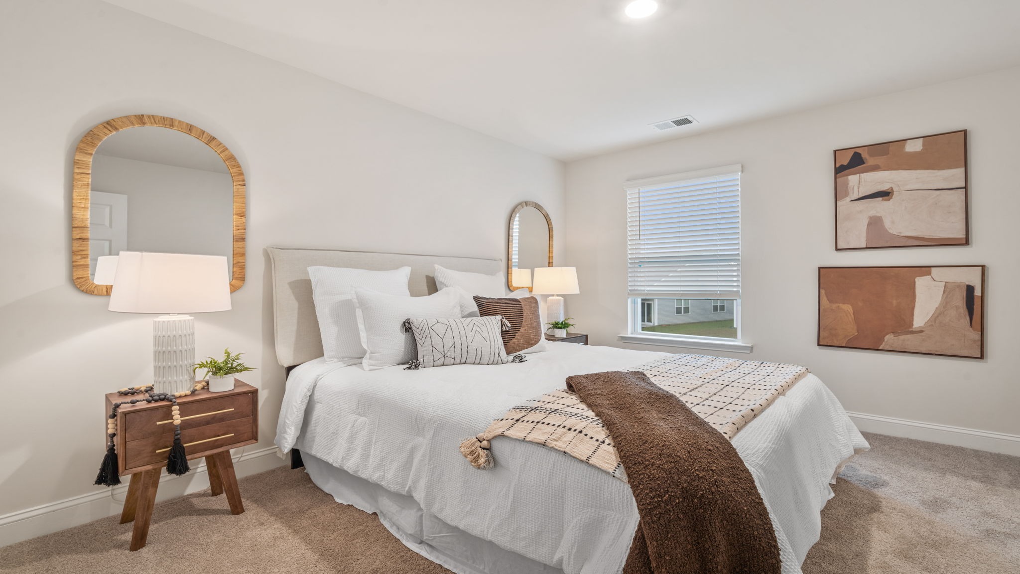 Luxurious primary bedroom in the Belhaven floorplan by D.R. Horton featuring large windows, abundant natural light, modern finishes, and a spacious owner's retreat.