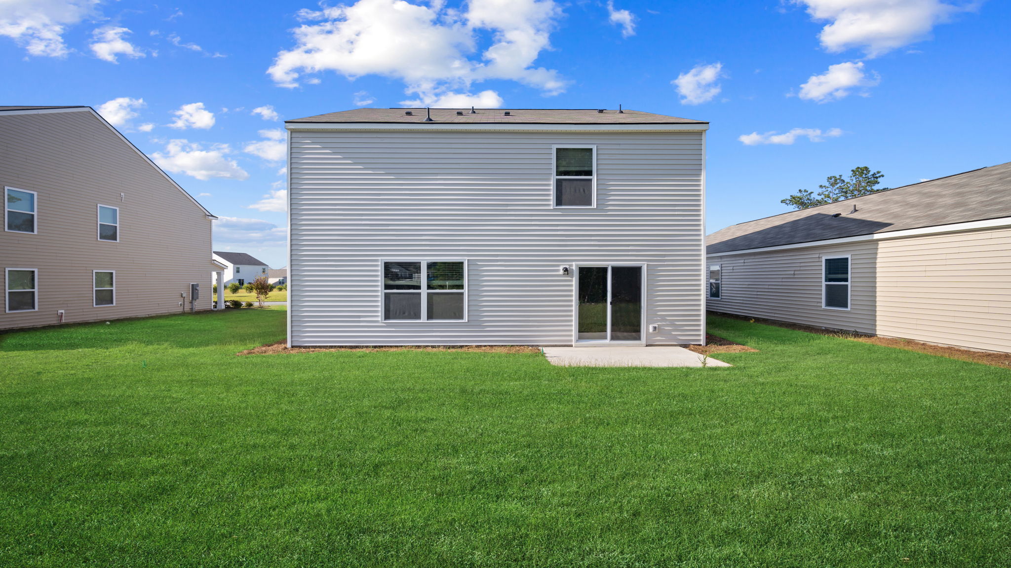 Rear exterior of the home showing a beautiful backyard.