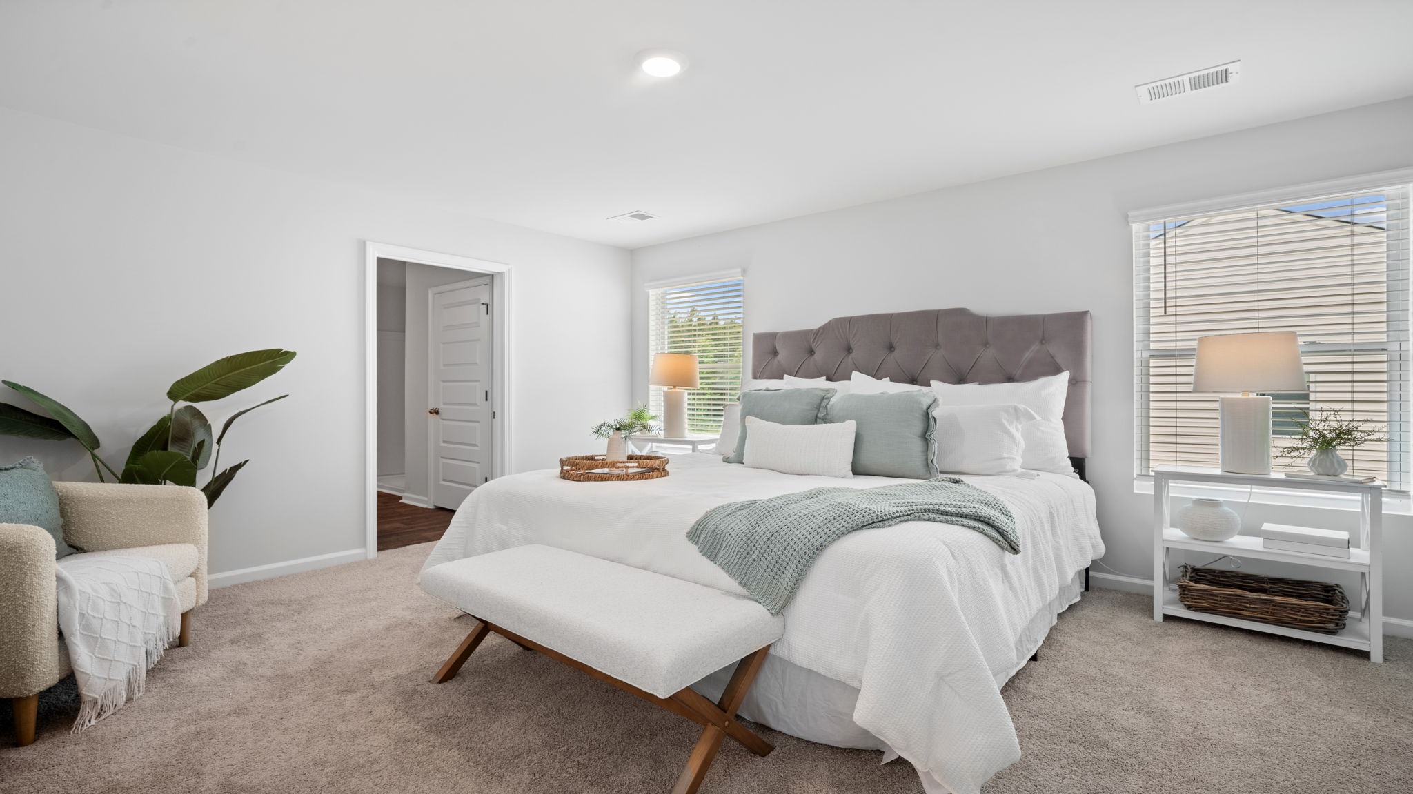 Primary bedroom decorated with a bed, side table and a dresser