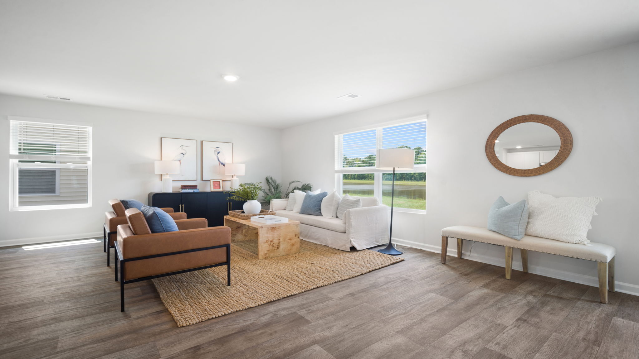Bright family room in the Elston floorplan featuring an open layout, abundant natural light, and comfortable living space for everyday relaxation and entertaining.