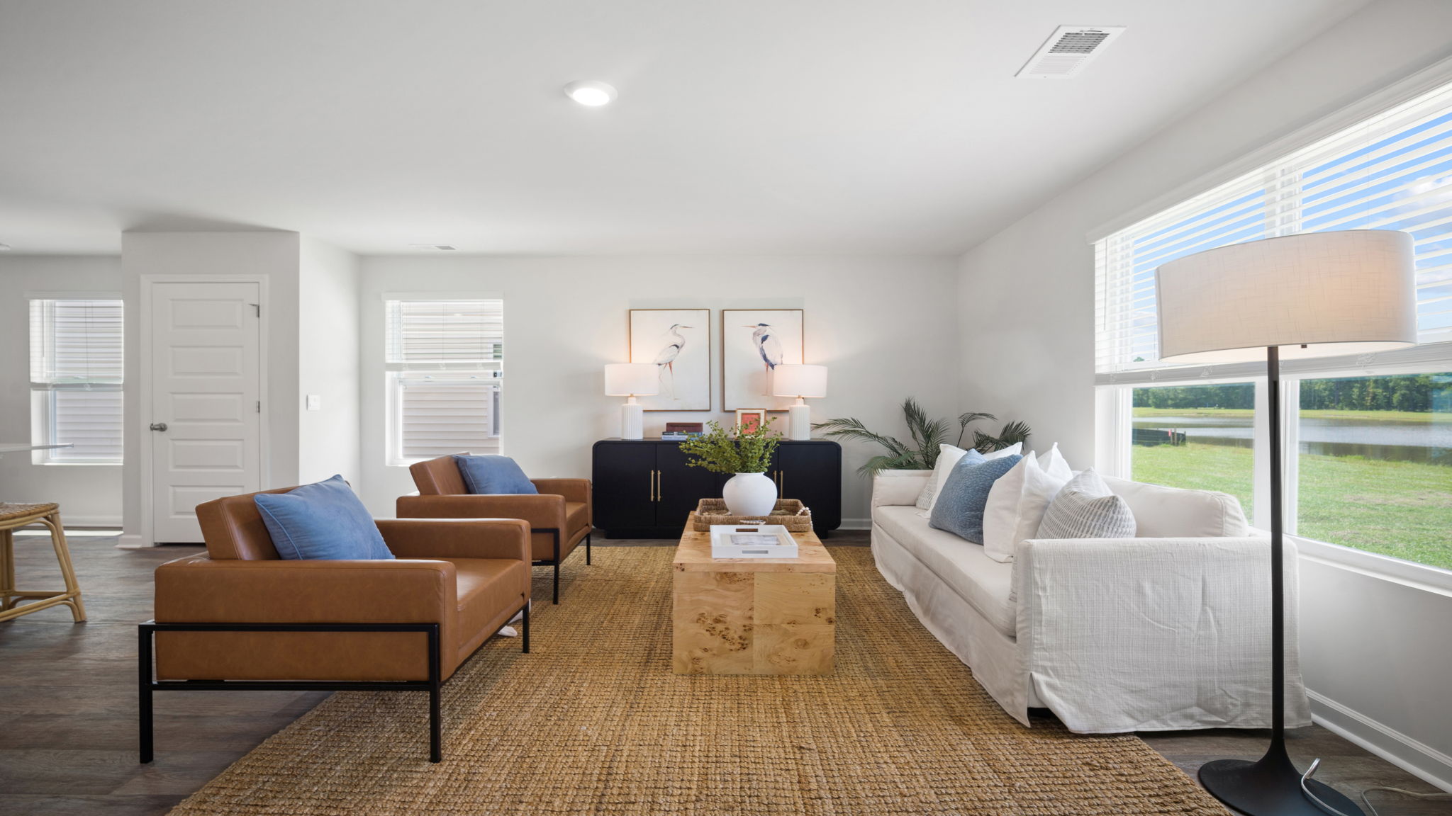 Spacious living room in the Elston by D.R. Horton showcasing modern design, flexible seating arrangements, and seamless connectivity to the main living areas.