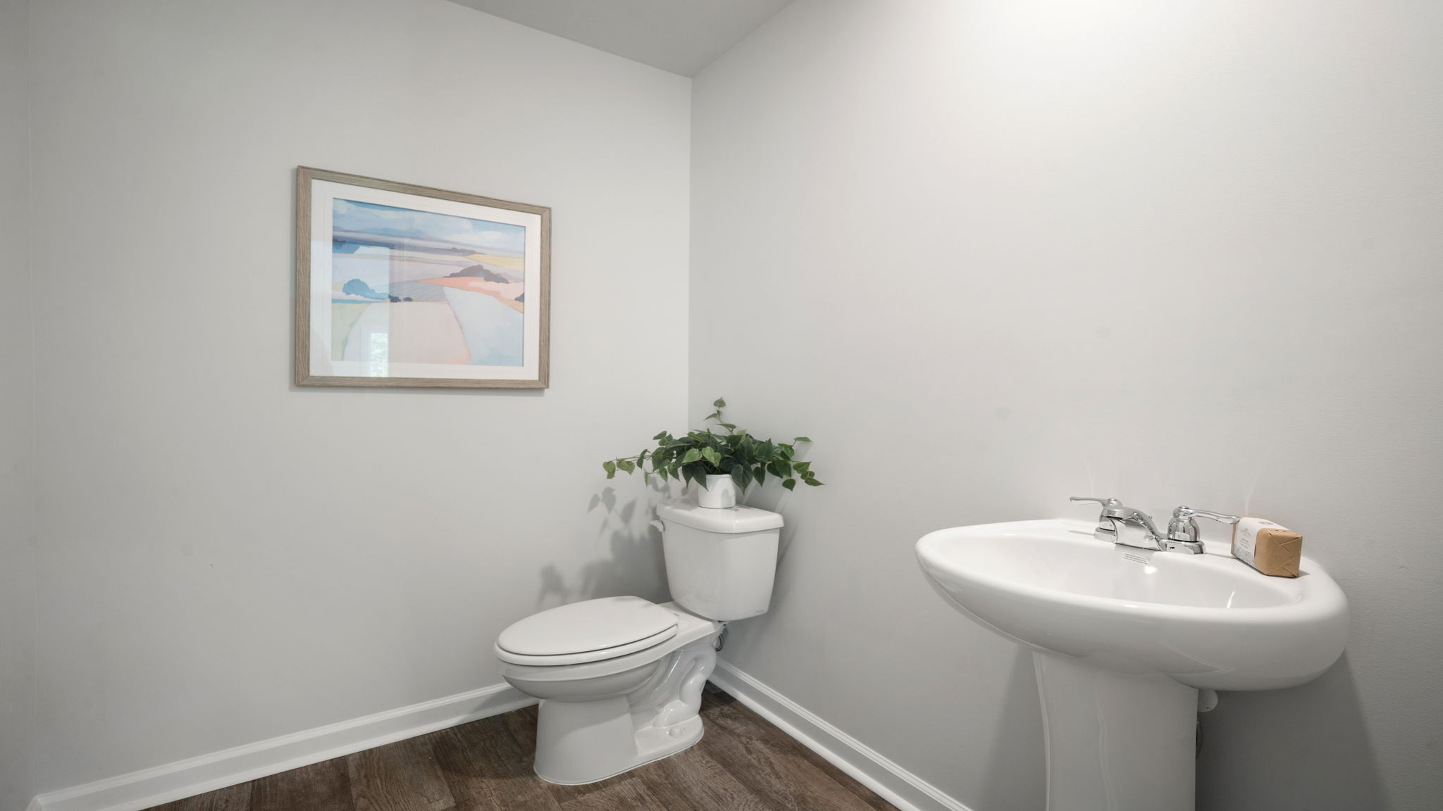 Elegant half bathroom in the Elston by D.R. Horton showcasing contemporary details, bright lighting, and thoughtfully designed convenience on the main level.