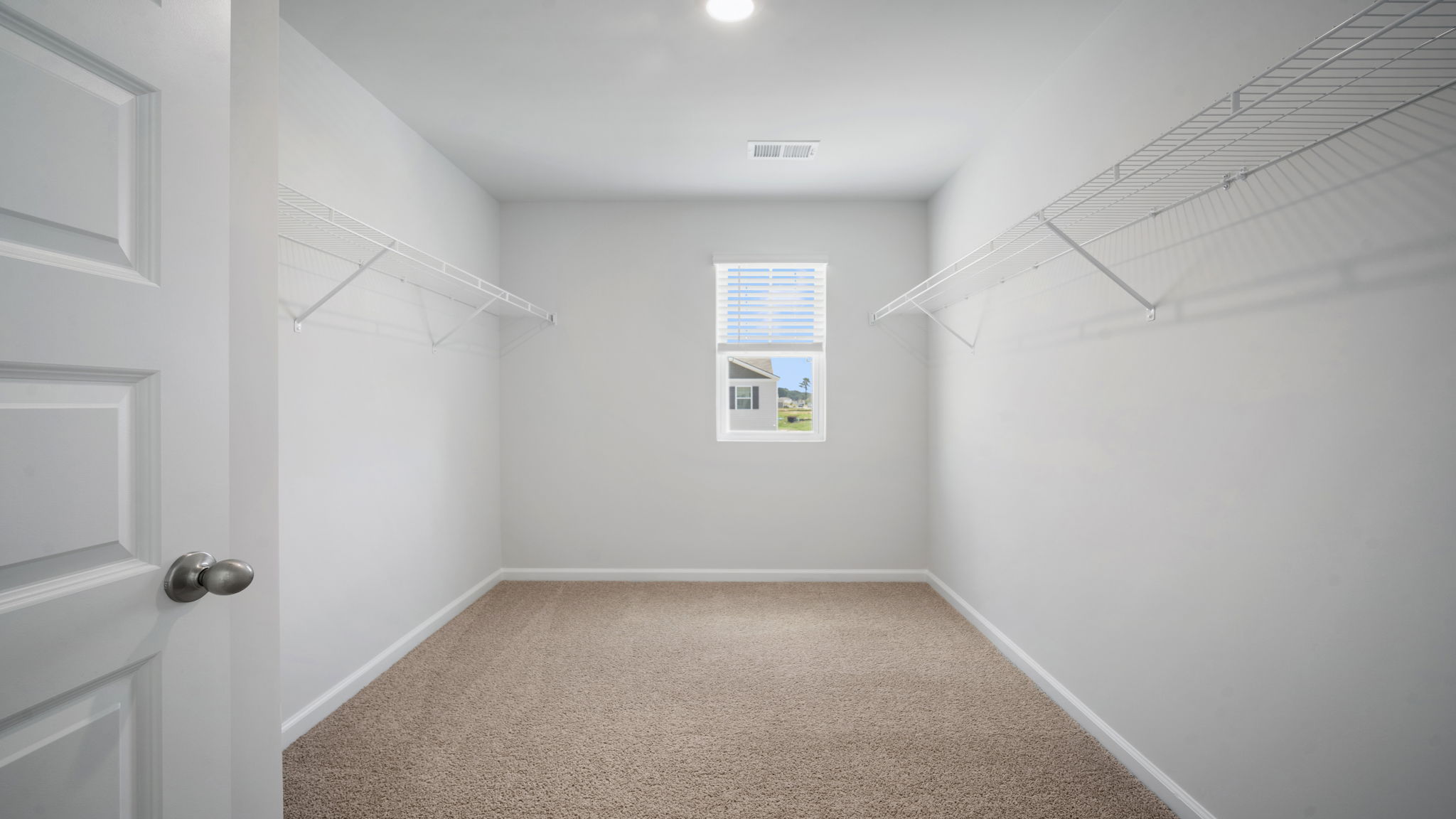 Expansive walk-in closet in the Elston floorplan providing abundant storage space and organization options within the private owner's suite.